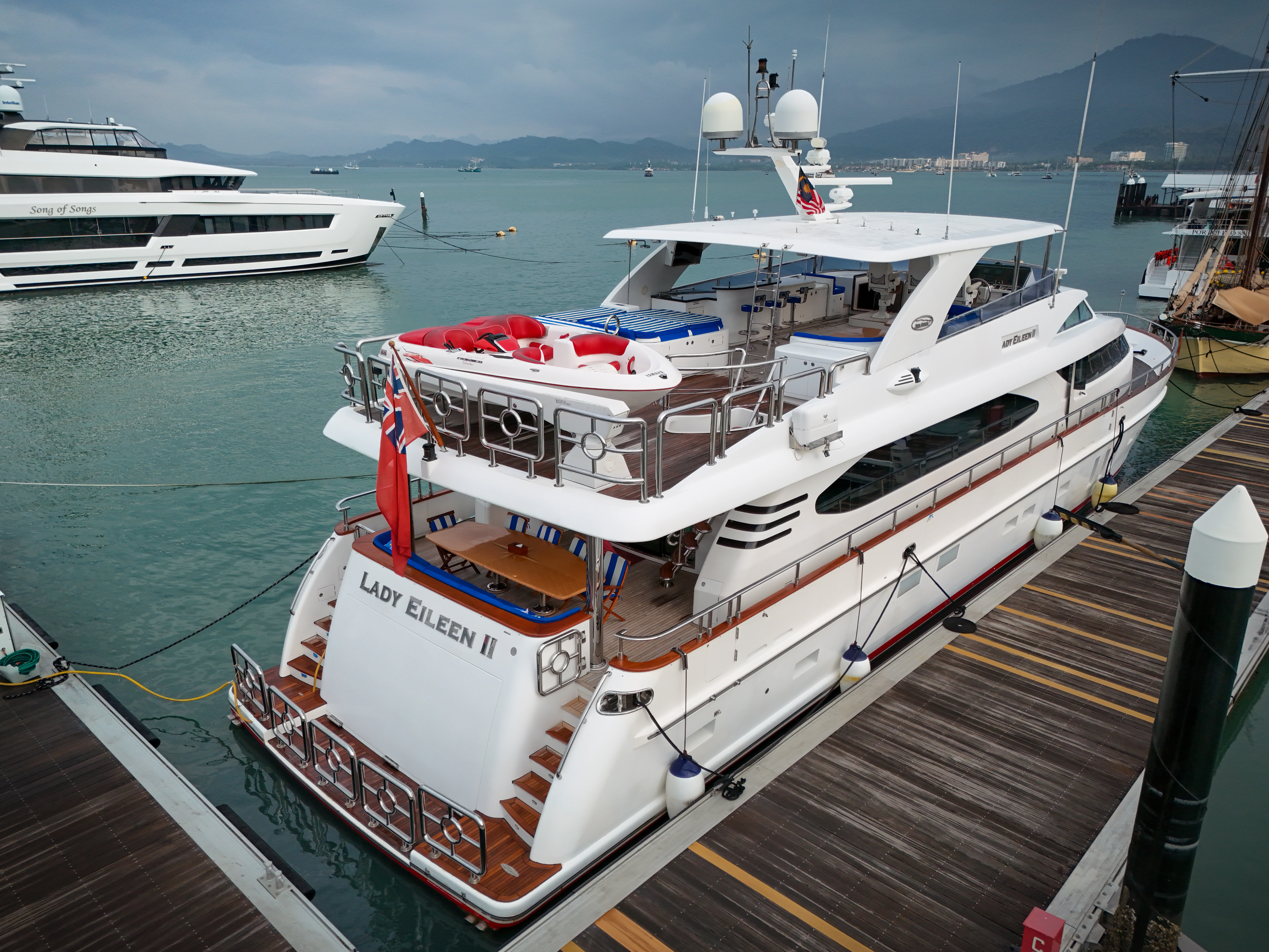 a large white boat docked at a pier aboard LADY EILEEN II Yacht for Sale