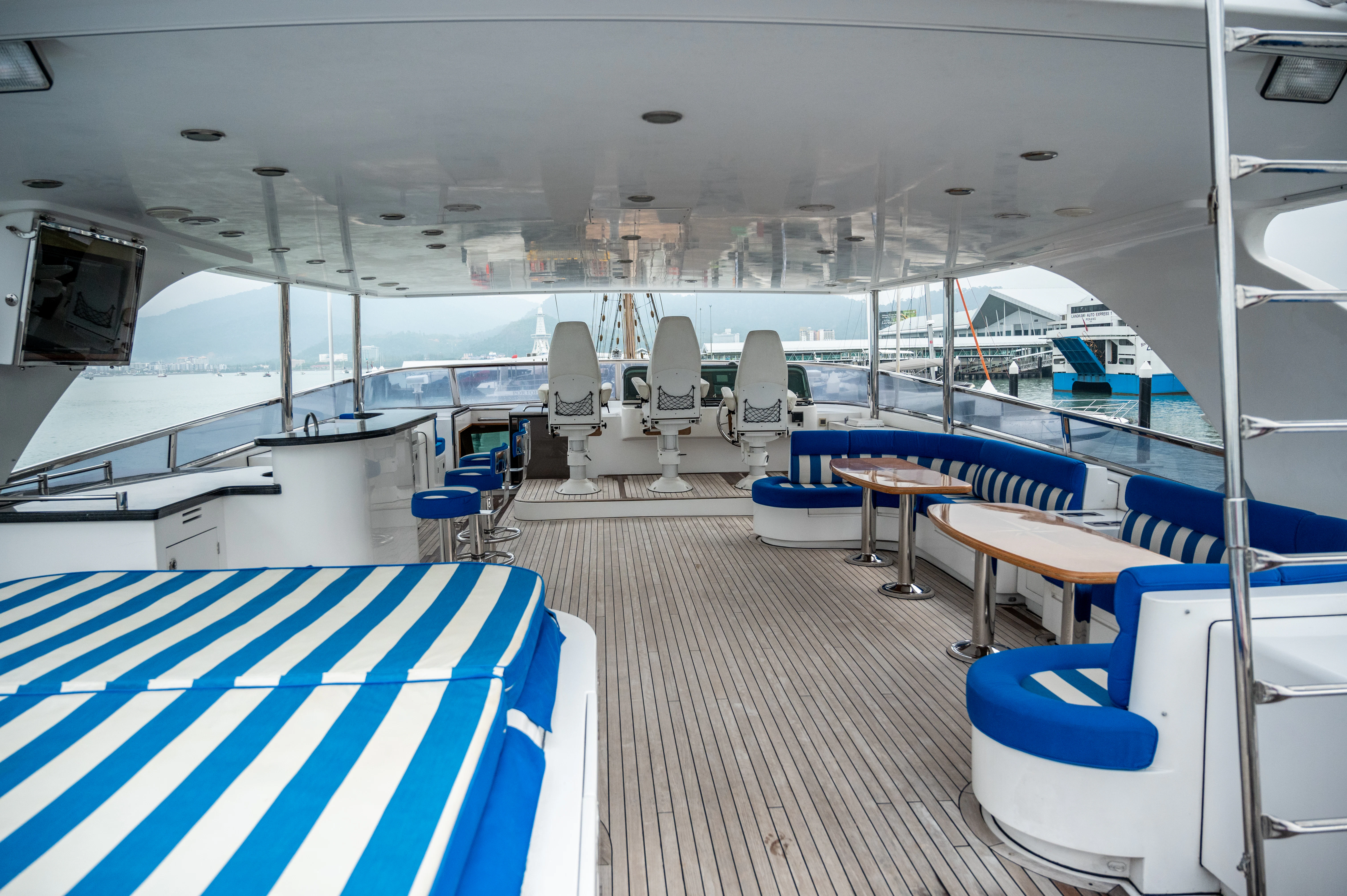 a room with a boat and chairs aboard LADY EILEEN II Yacht for Sale