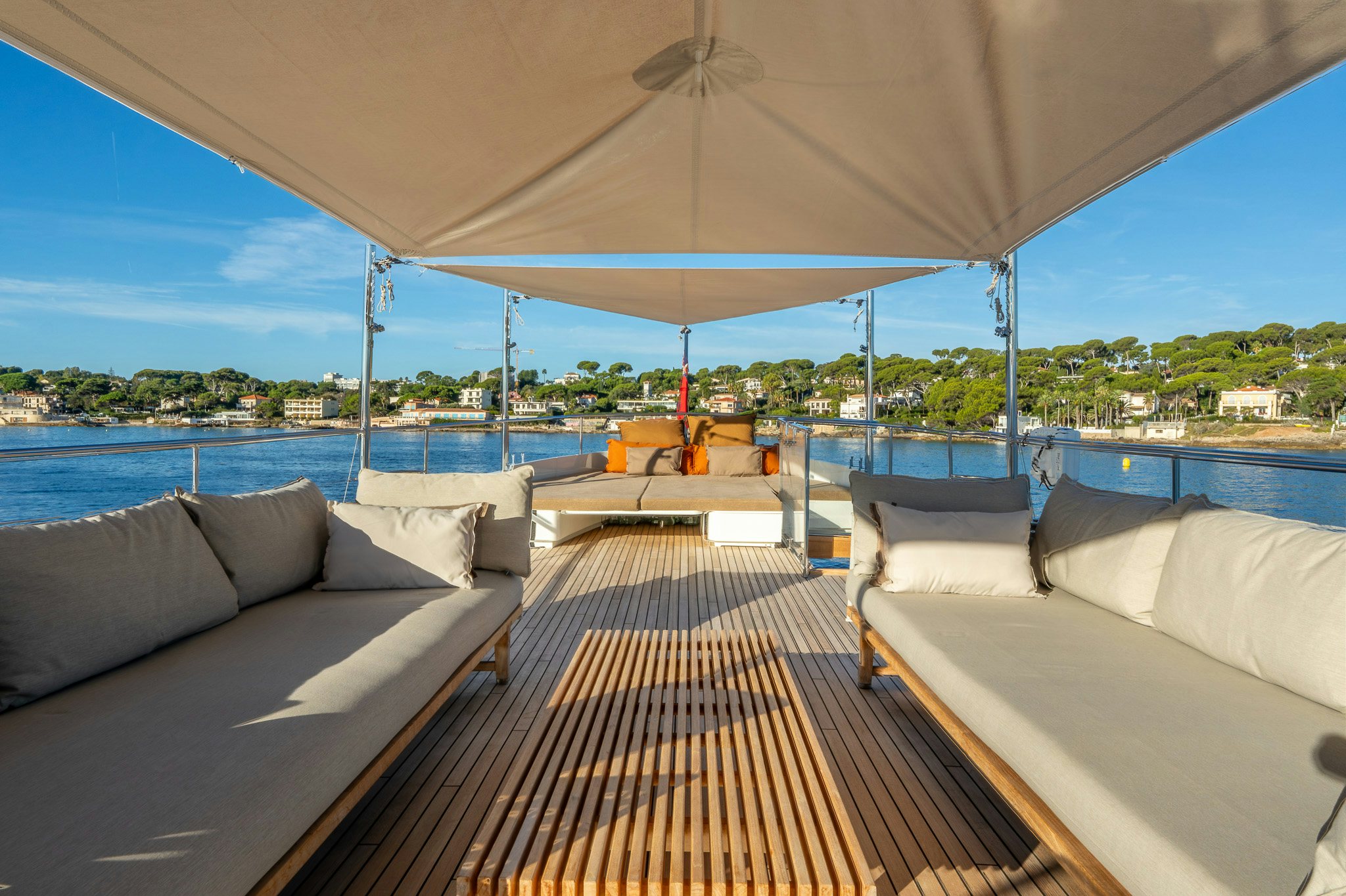a deck with a large body of water and a large boat in the background aboard SULTANA Yacht for Sale
