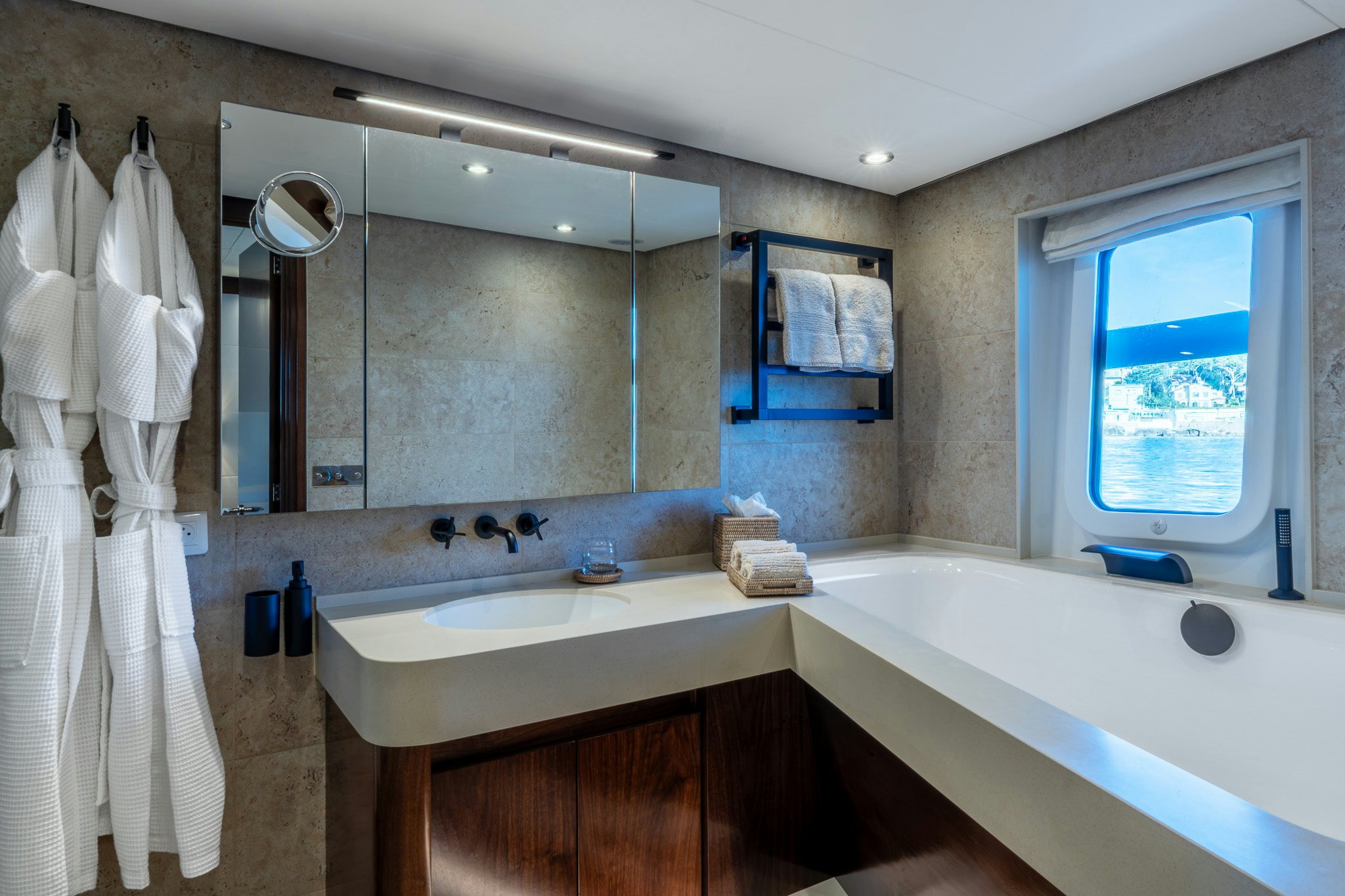 a bathroom with a bathtub sink and a mirror aboard SULTANA Yacht for Sale
