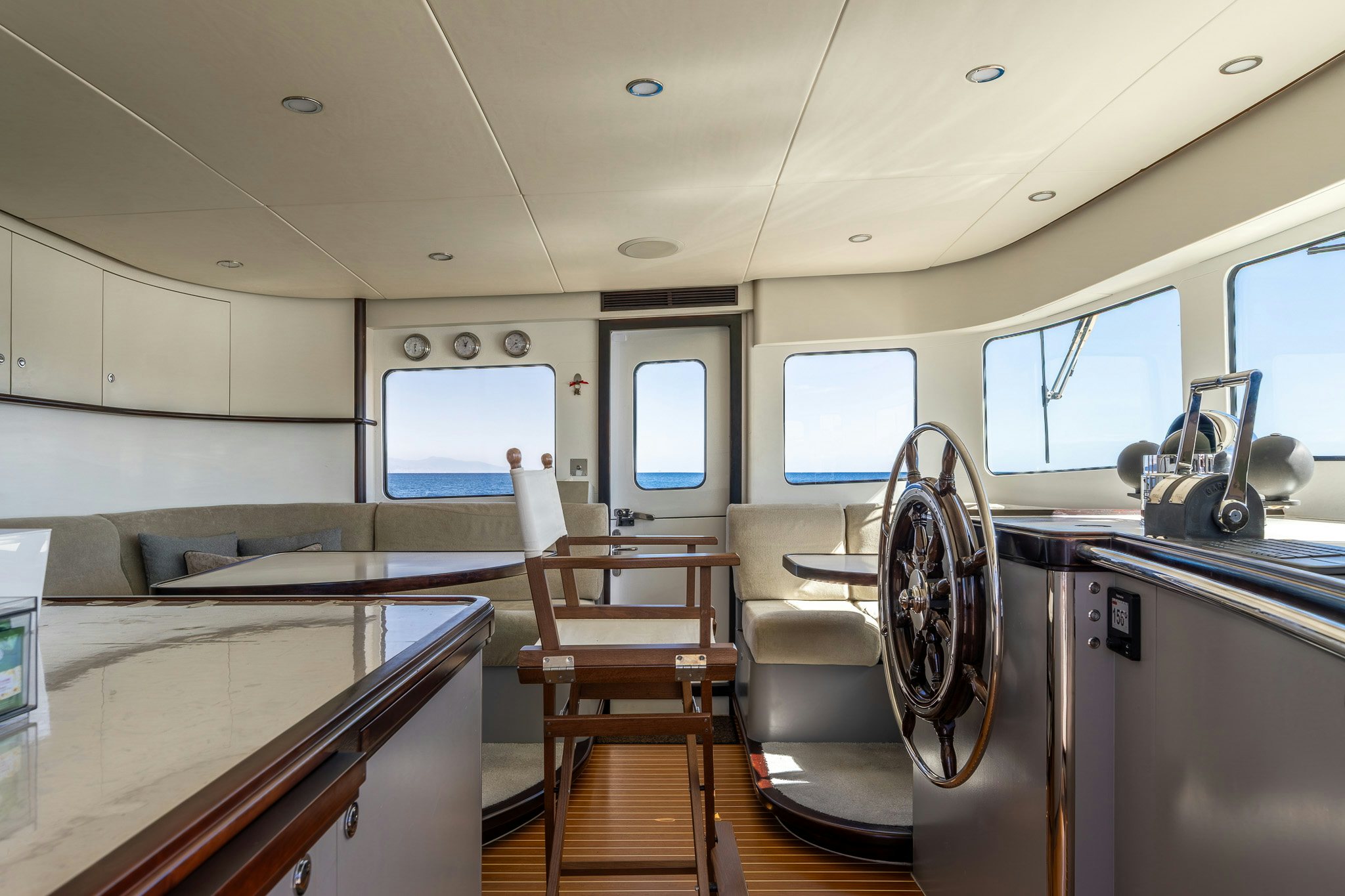 a room with a chair and a table and a window aboard SULTANA Yacht for Sale