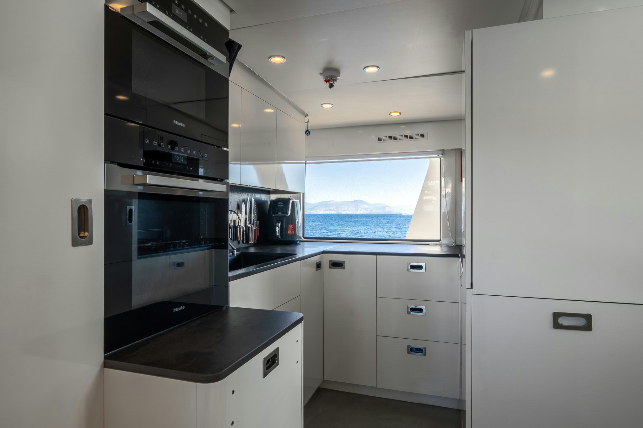 a kitchen with a large window aboard SULTANA Yacht for Sale