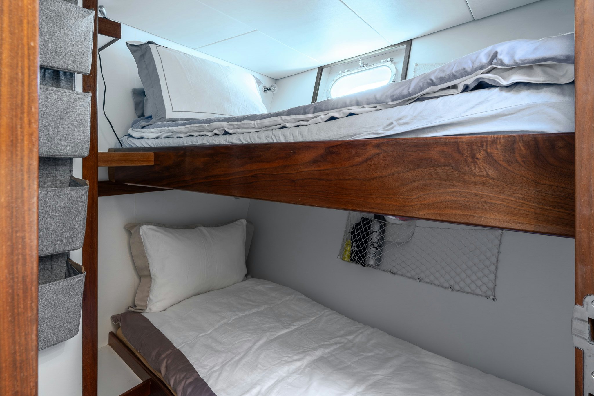 a bed with white sheets aboard SULTANA Yacht for Sale