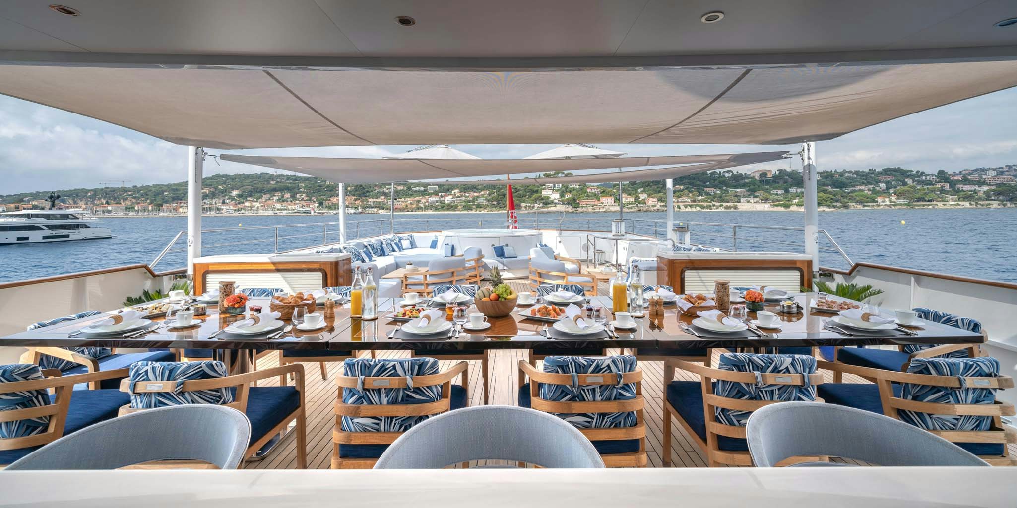 a table set for a meal on a boat aboard SYNTHESIS 66 Yacht for Charter
