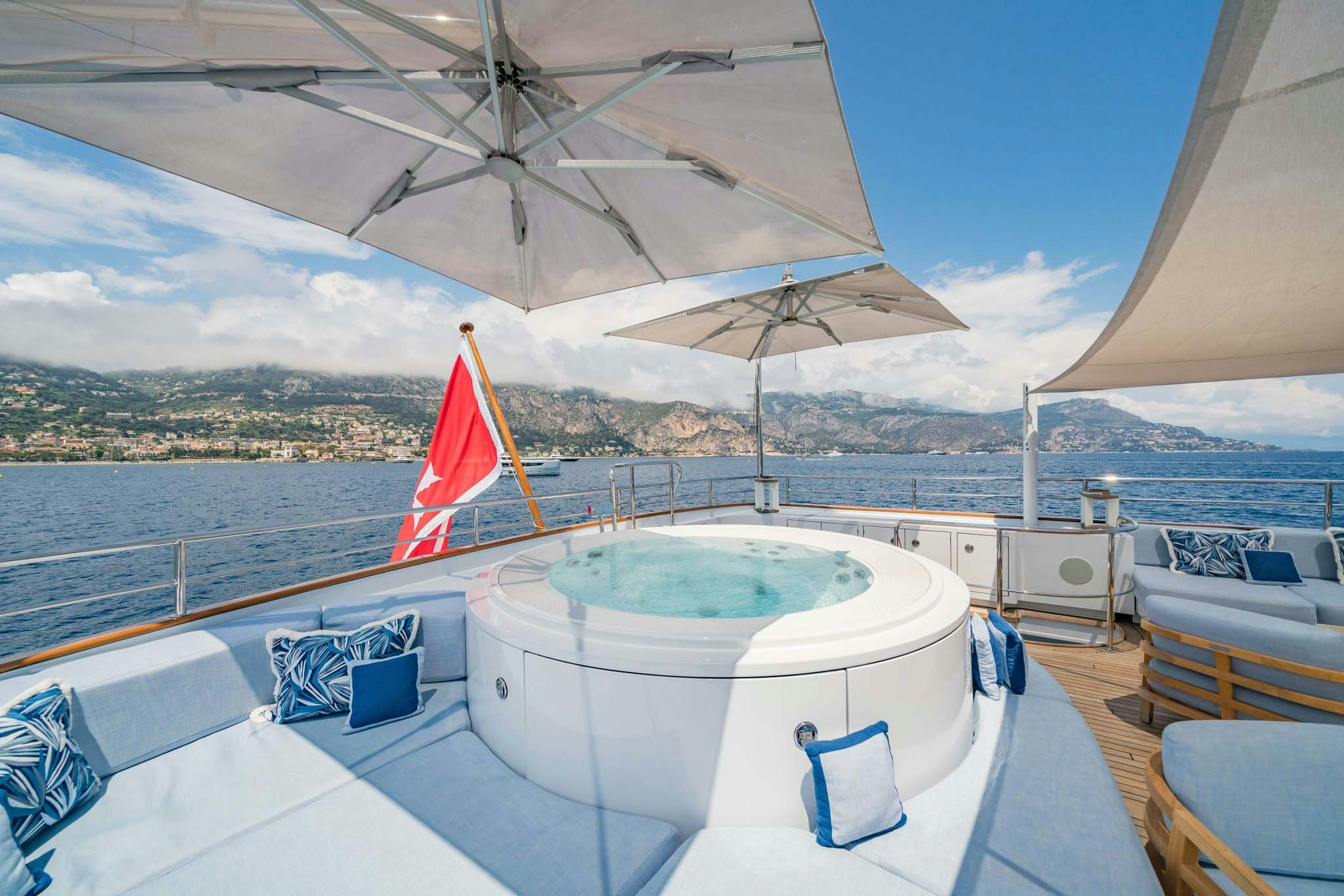a pool with a large umbrella aboard SYNTHESIS 66 Yacht for Charter