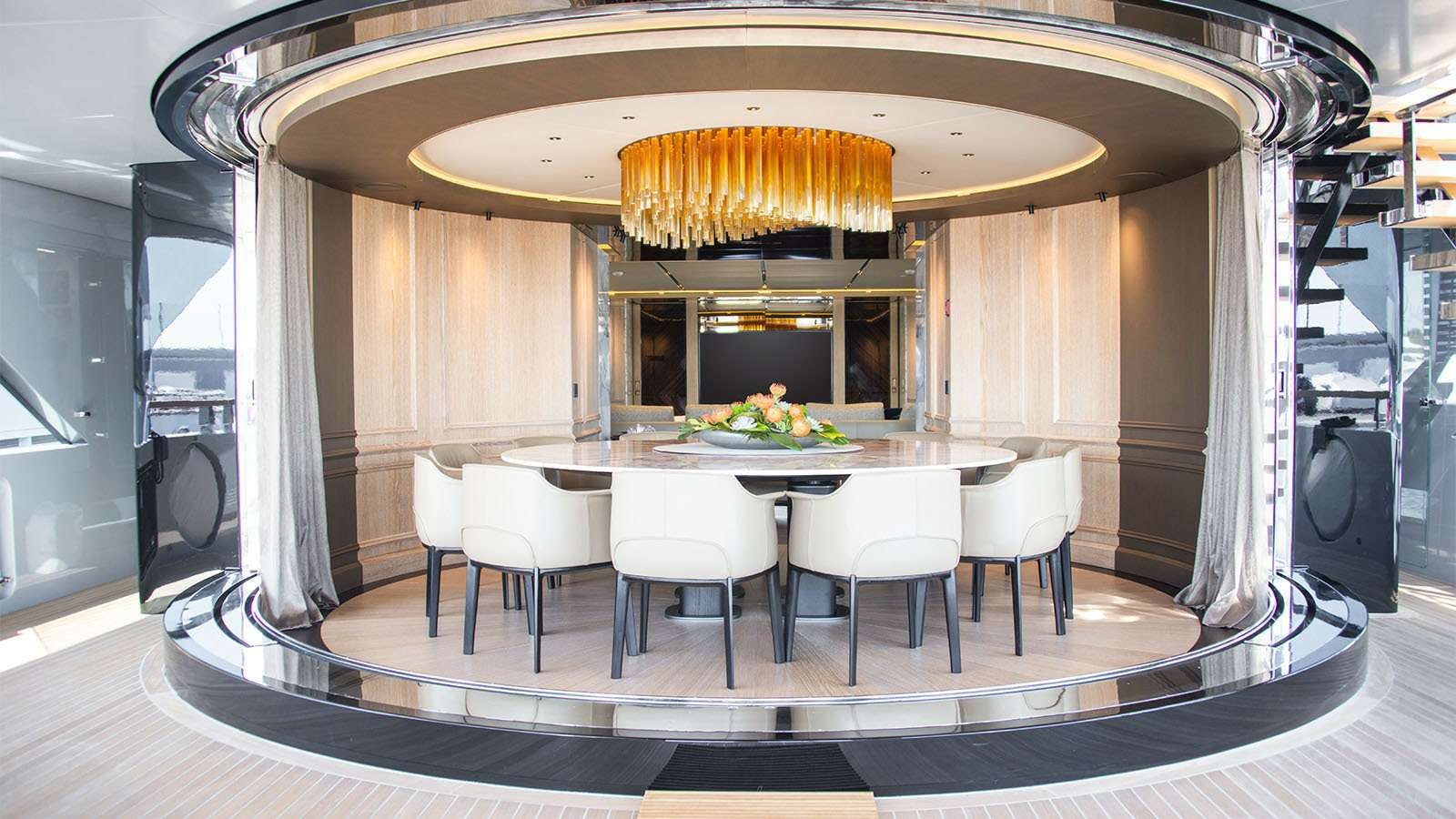 a large dining table in a room aboard GECO Yacht for Charter