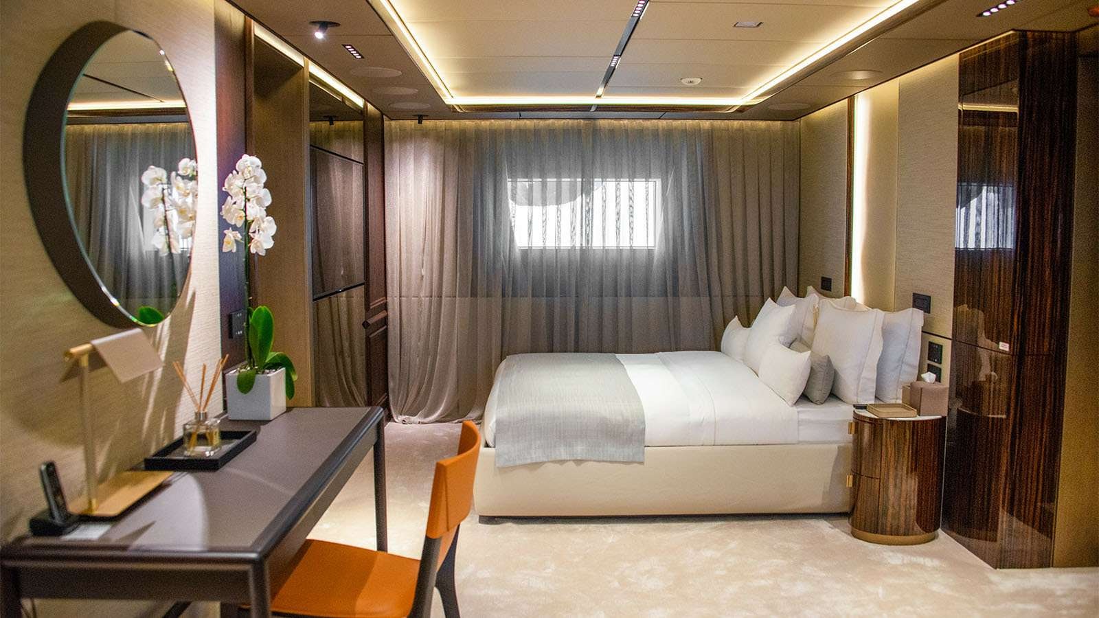 a room with a bed and a desk aboard GECO Yacht for Charter