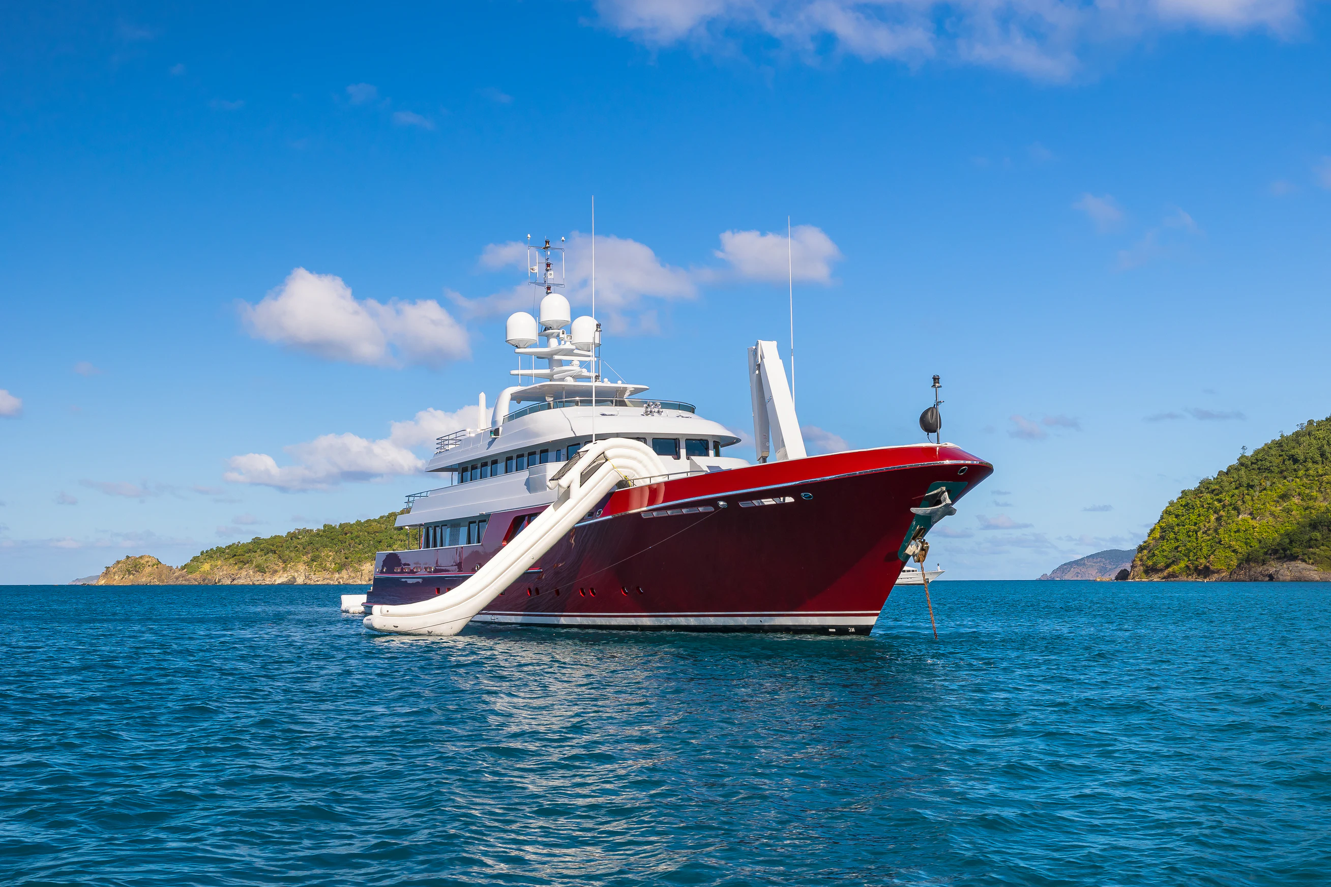 a red and white boat in the water aboard AVALON Yacht for Charter