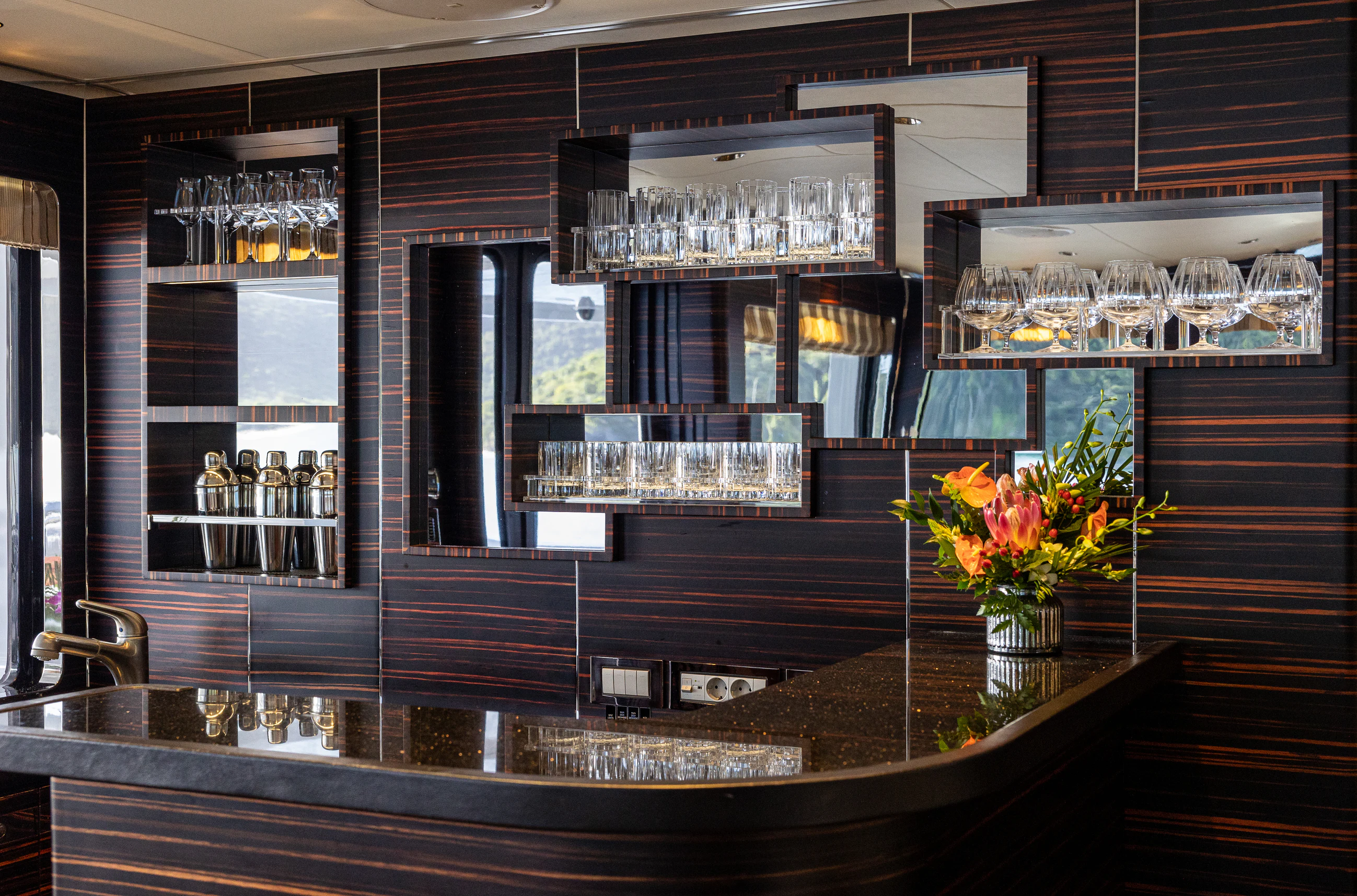 a bar with a large glass wall aboard AVALON Yacht for Charter