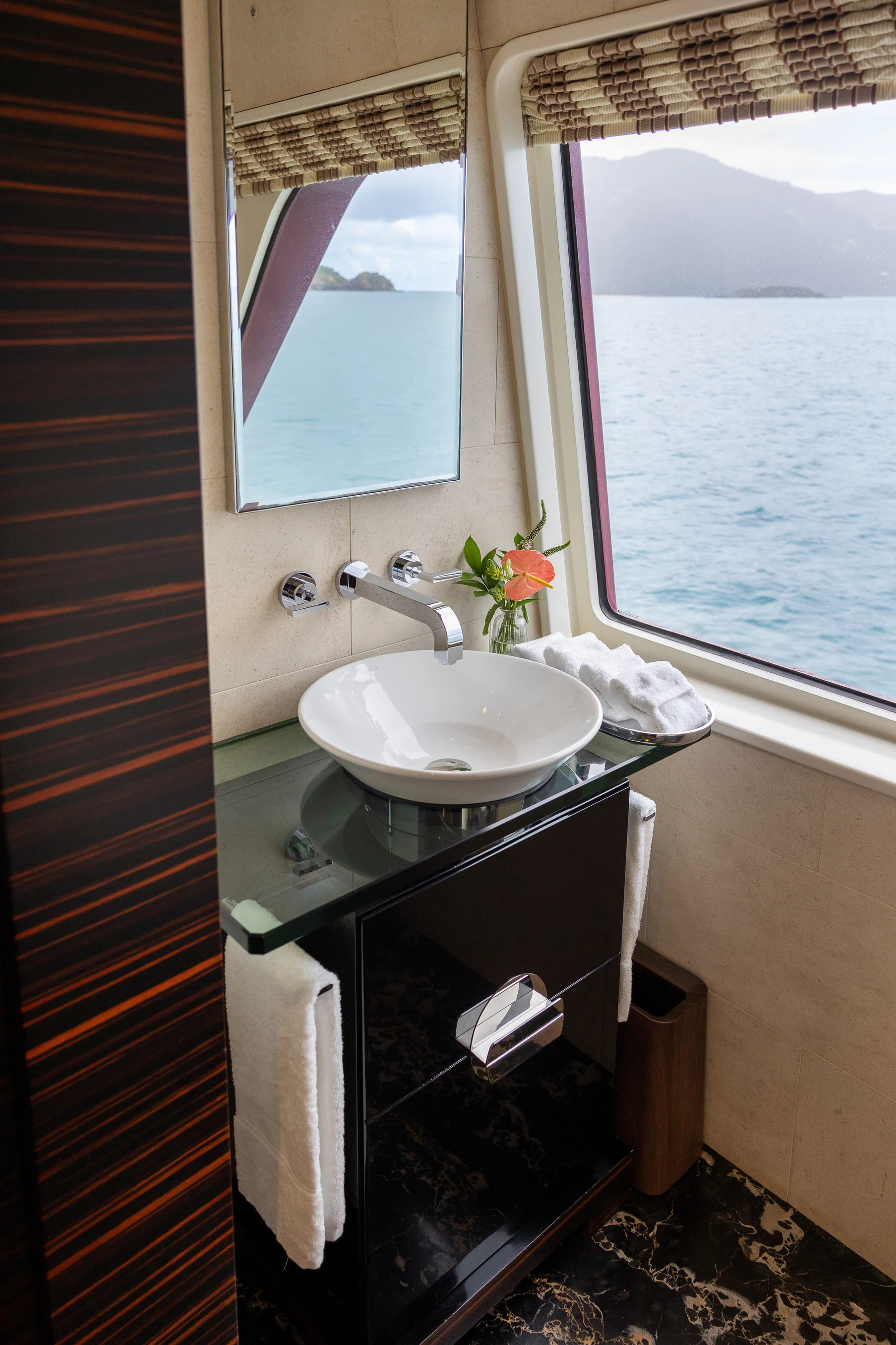 a bathroom with a sink and a window aboard AVALON Yacht for Charter