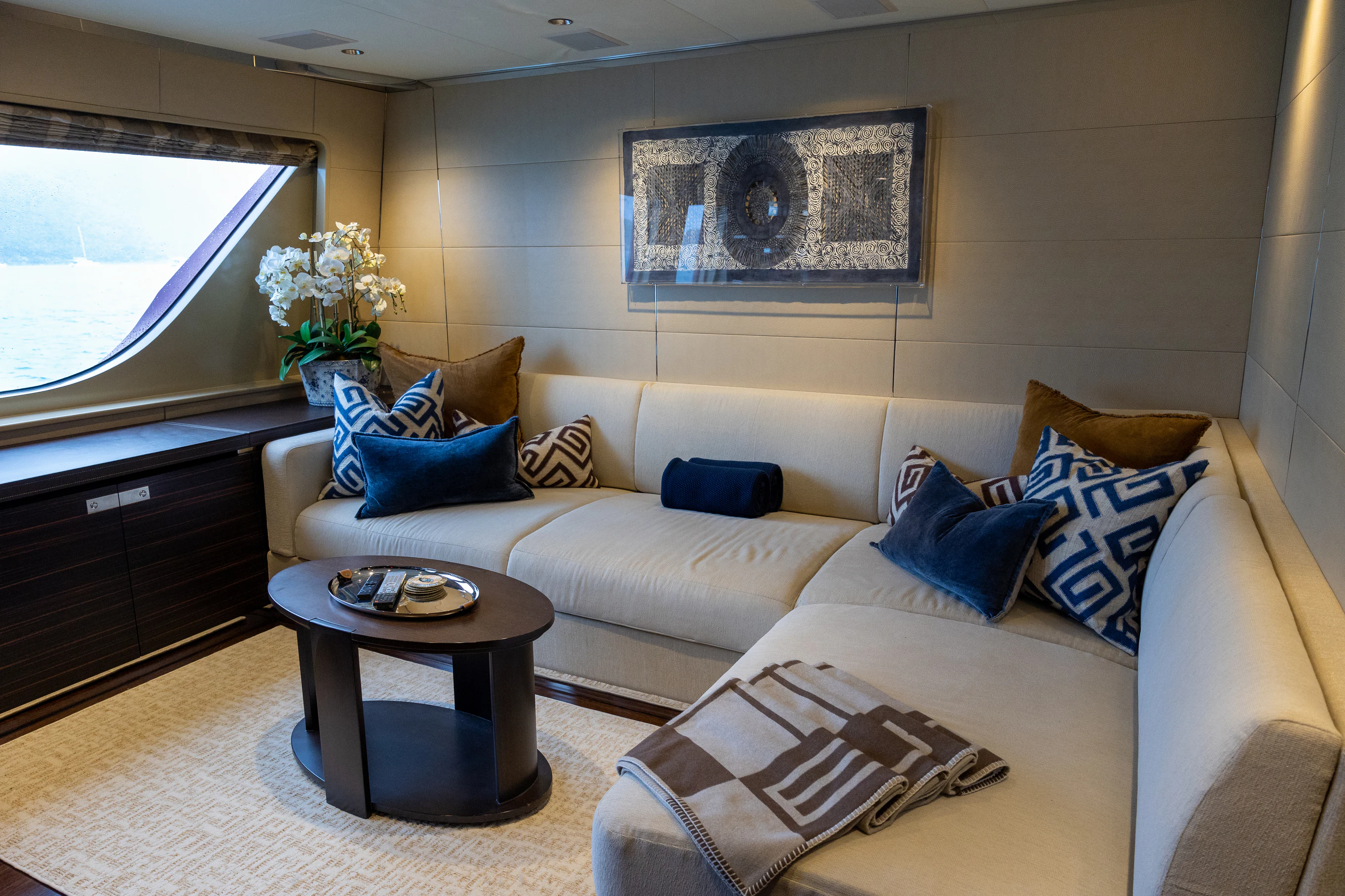 a living room with a couch and a coffee table aboard AVALON Yacht for Charter