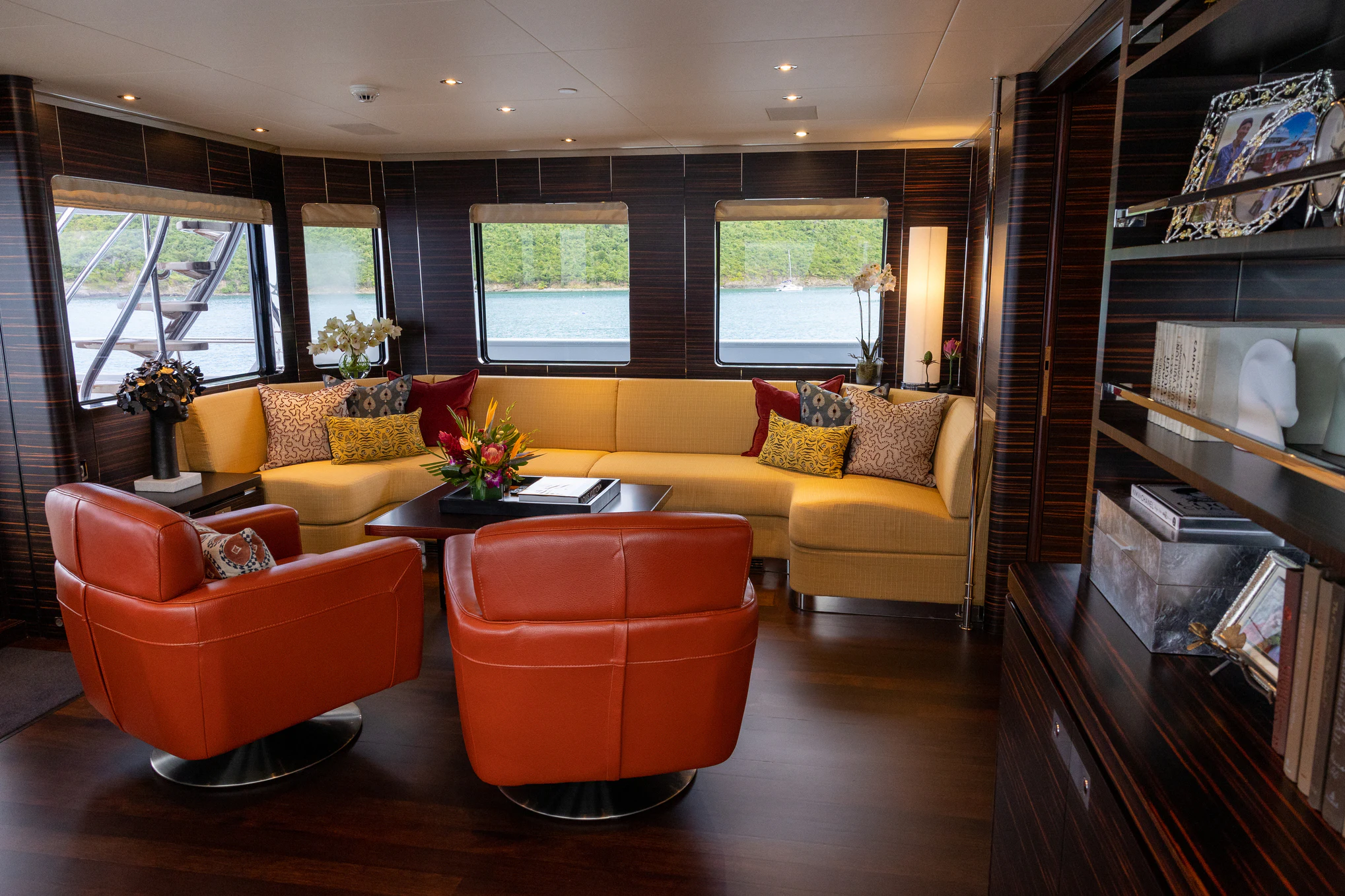 a living room with orange furniture aboard AVALON Yacht for Charter