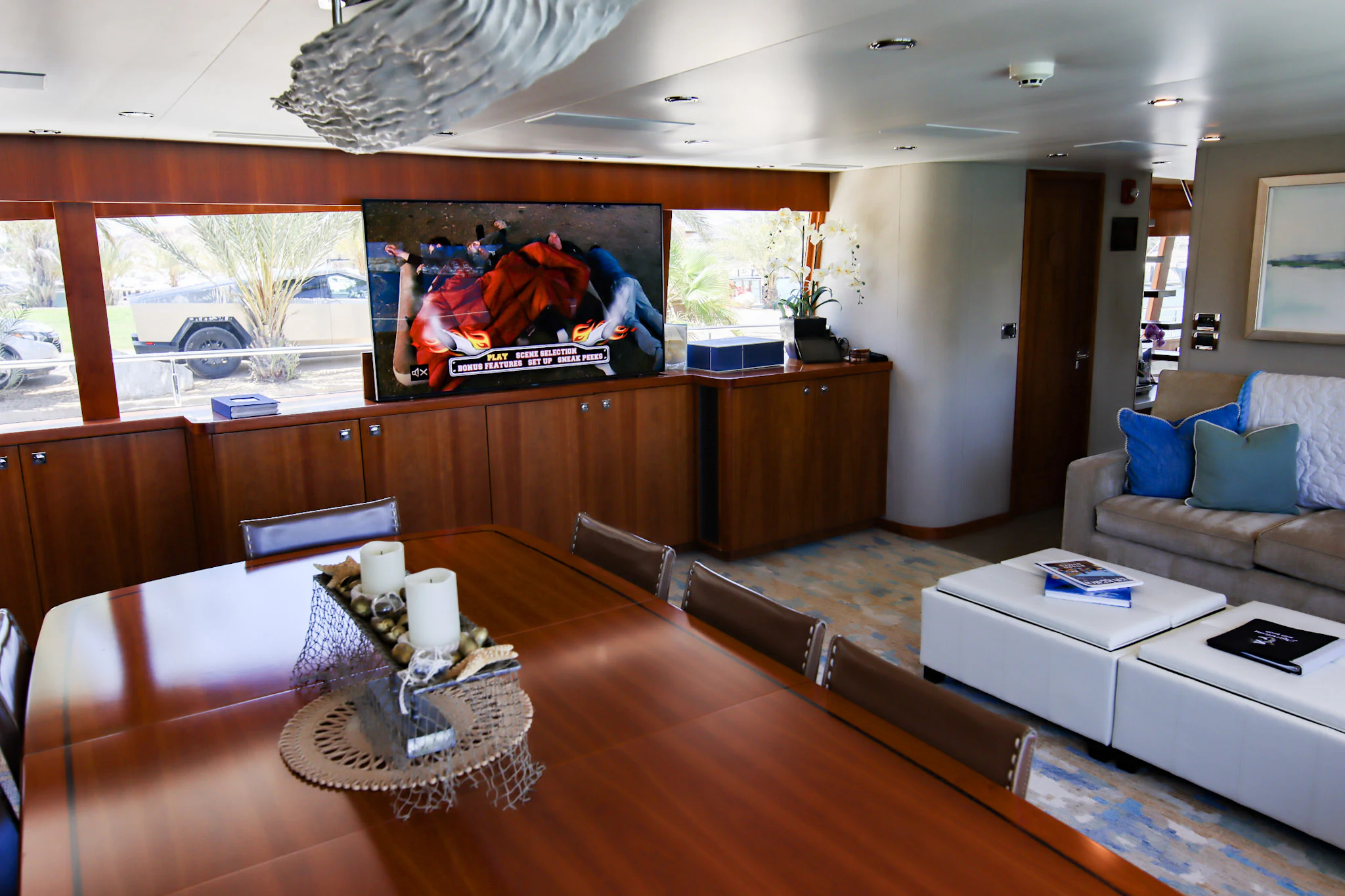 a living room with a large wood table and a couch aboard MARDIOSA Yacht for Sale
