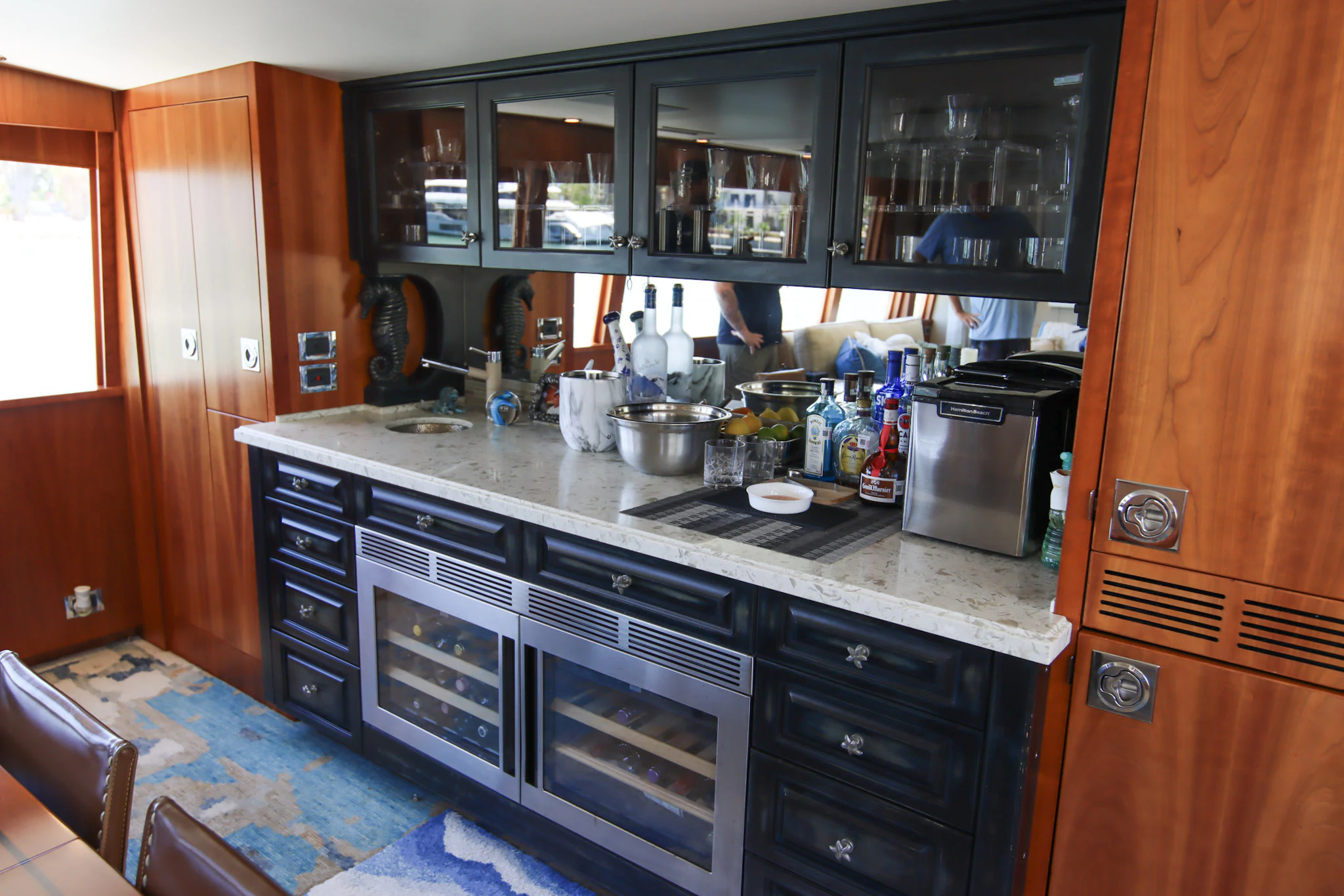 a kitchen with black appliances aboard MARDIOSA Yacht for Sale