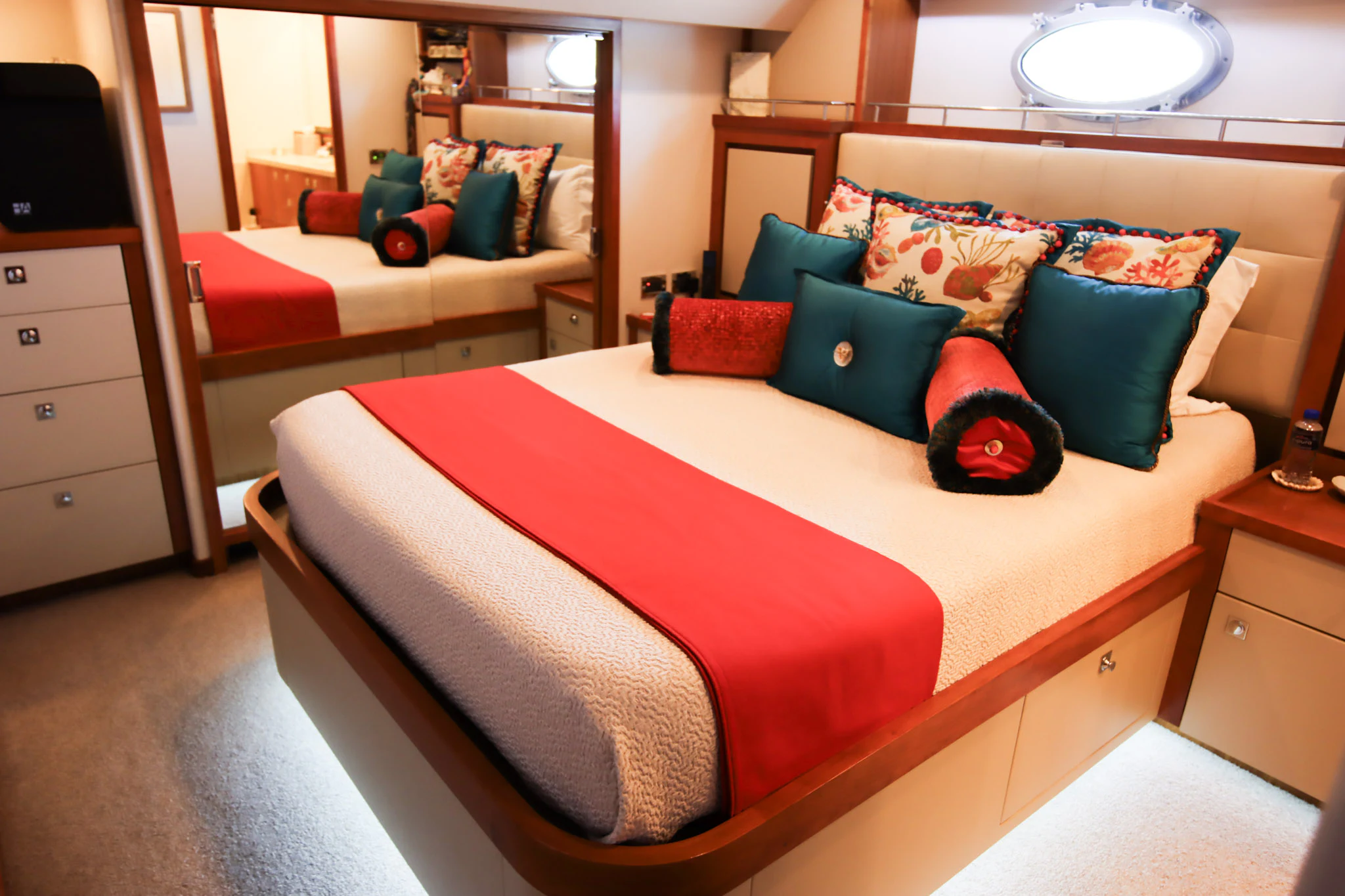 a bed with a red and blue bed spread aboard MARDIOSA Yacht for Sale