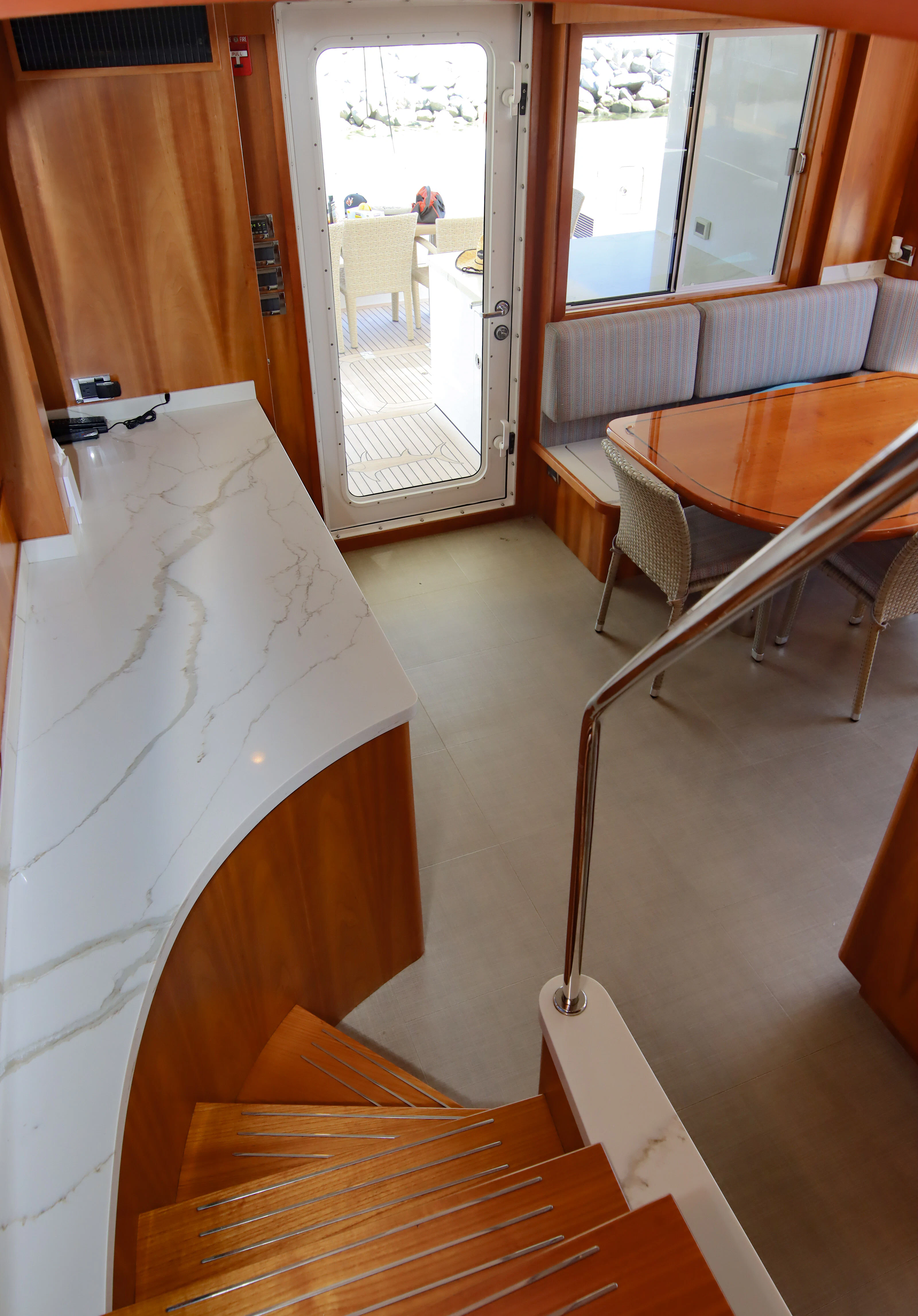 a room with a bench and a table and chairs aboard MARDIOSA Yacht for Sale