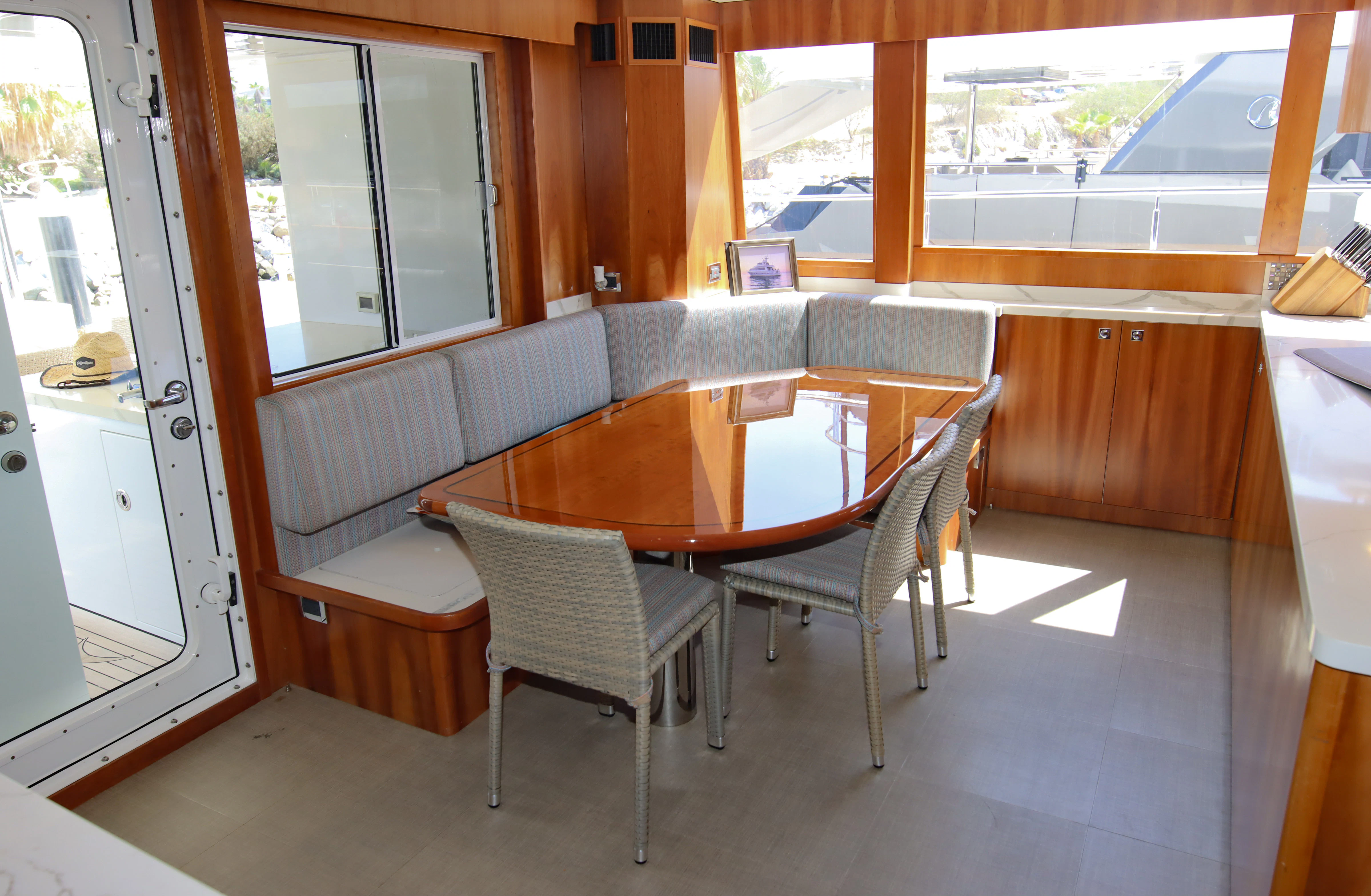 a dining table and chairs in a room with a window aboard MARDIOSA Yacht for Sale
