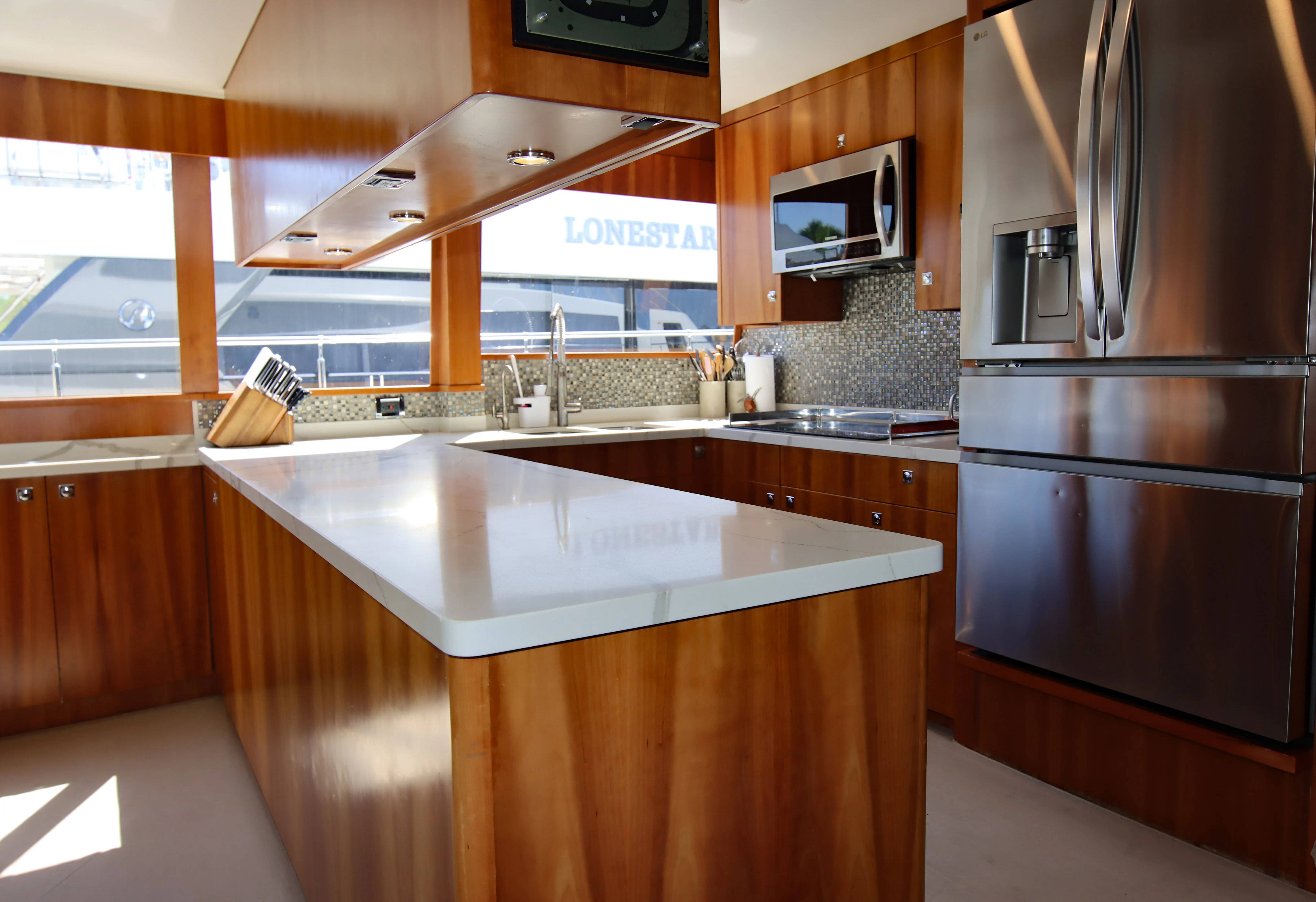 a kitchen with a stainless steel refrigerator aboard MARDIOSA Yacht for Sale