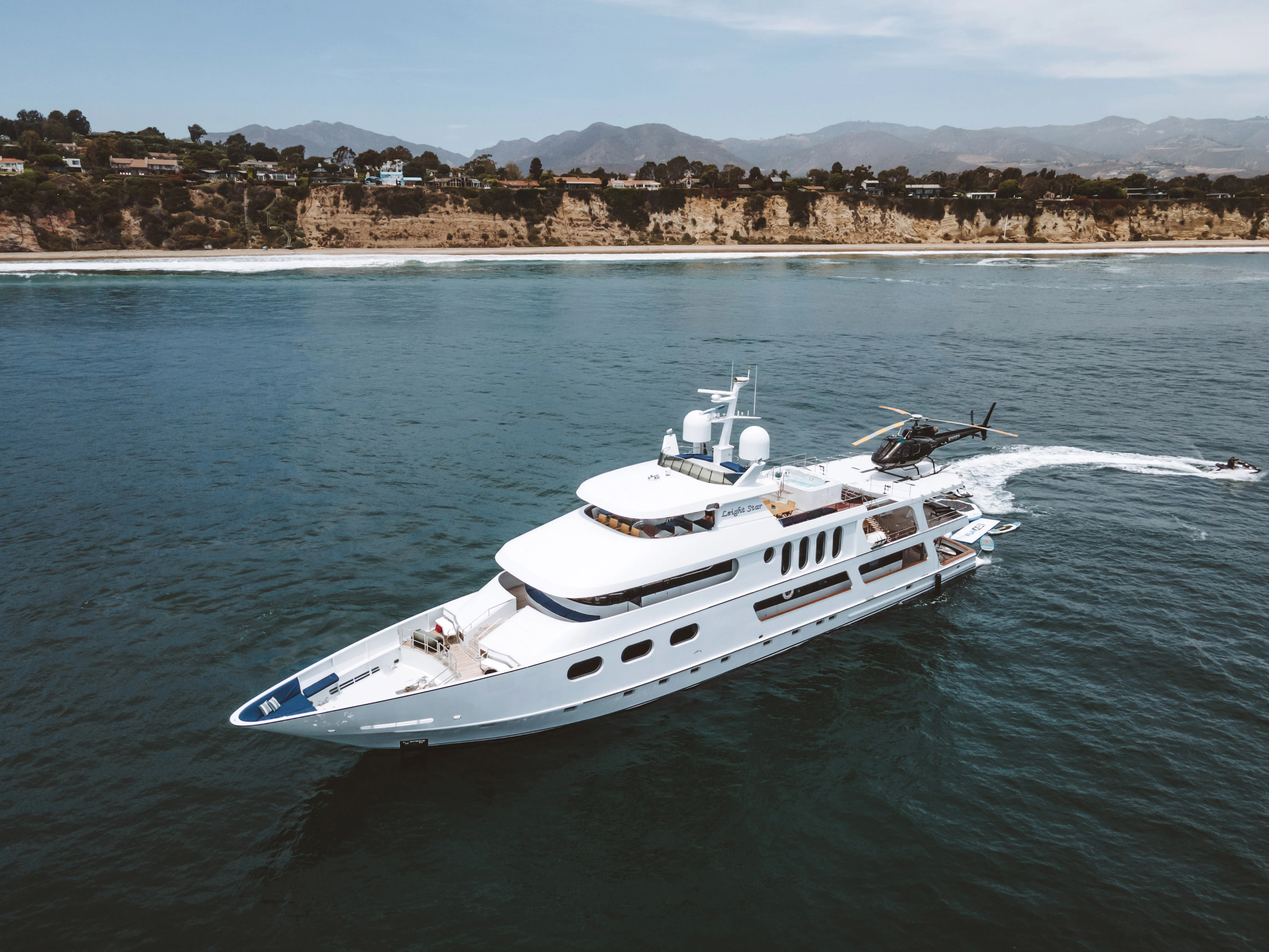 a white boat on the water aboard AURORA Yacht for Sale