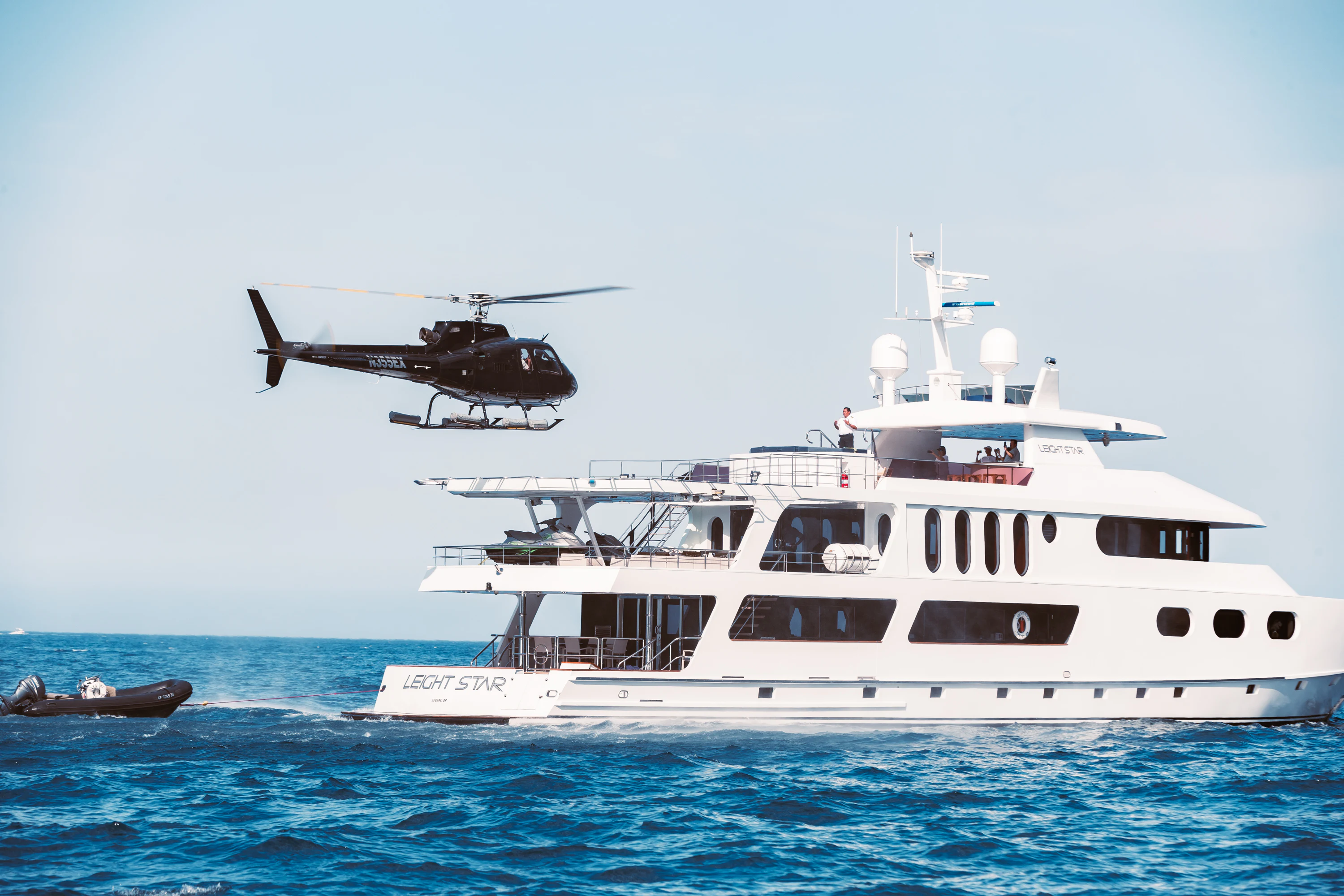 a helicopter flying over a boat aboard AURORA Yacht for Sale