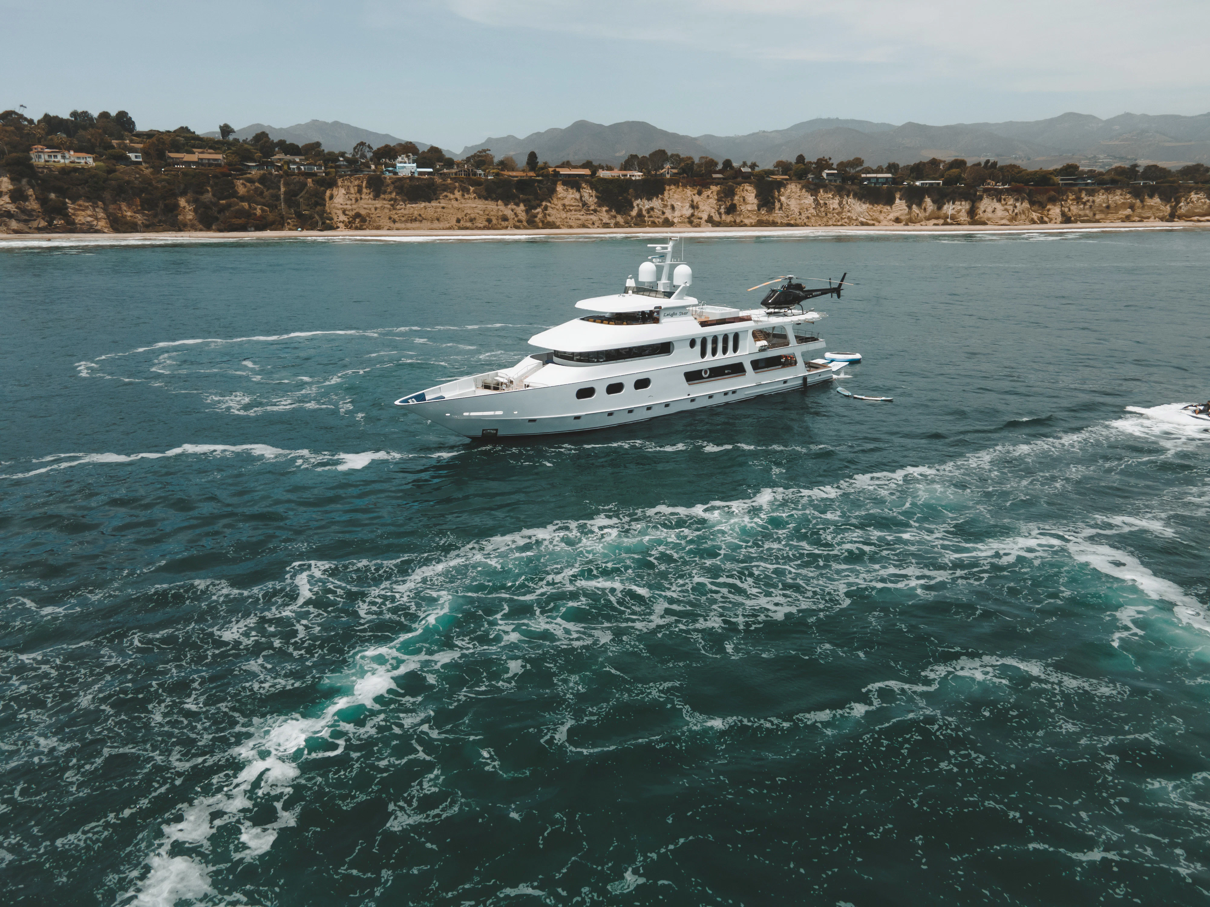 a white boat on the water aboard AURORA Yacht for Sale