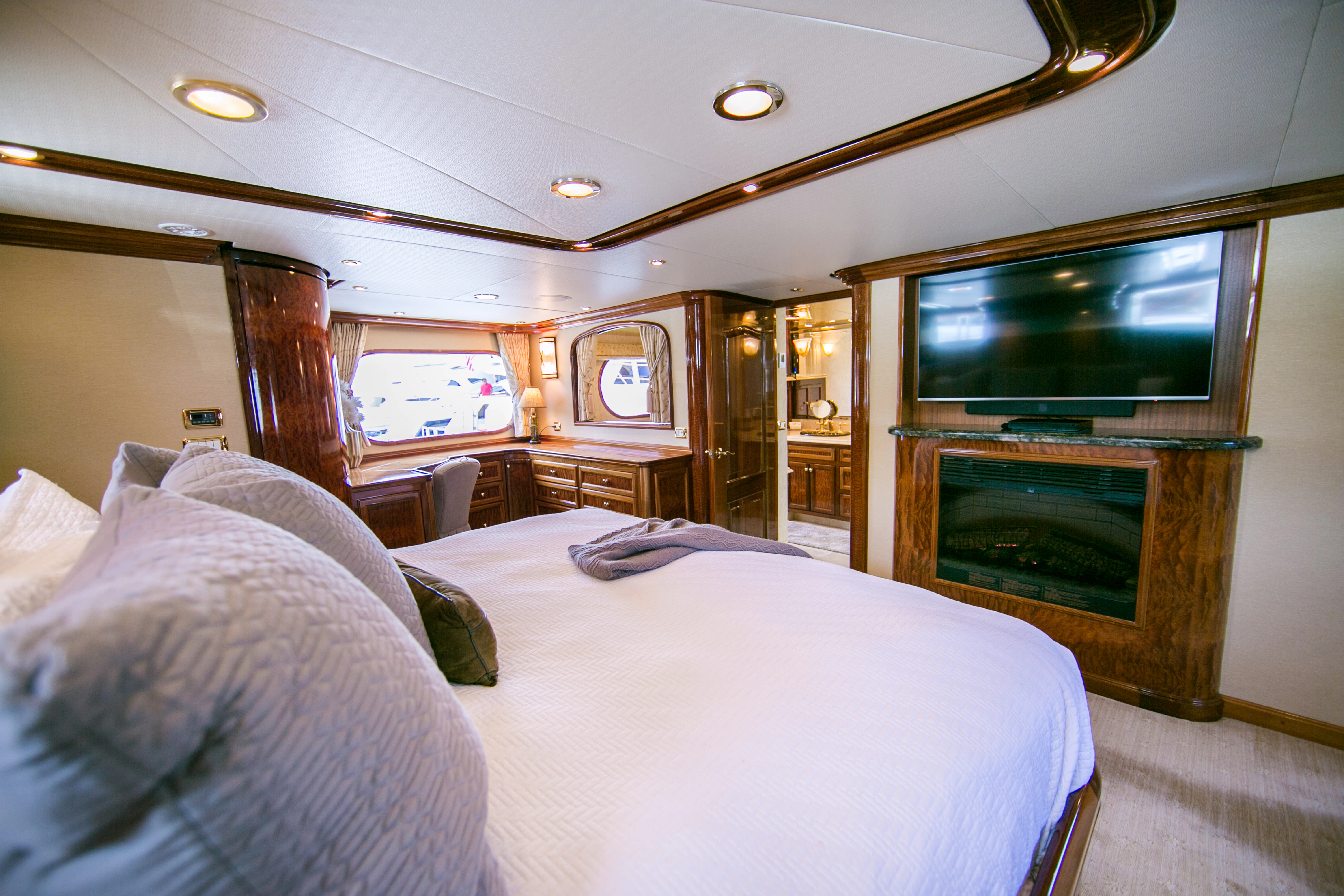 a bedroom with a bed and a television aboard AURORA Yacht for Sale