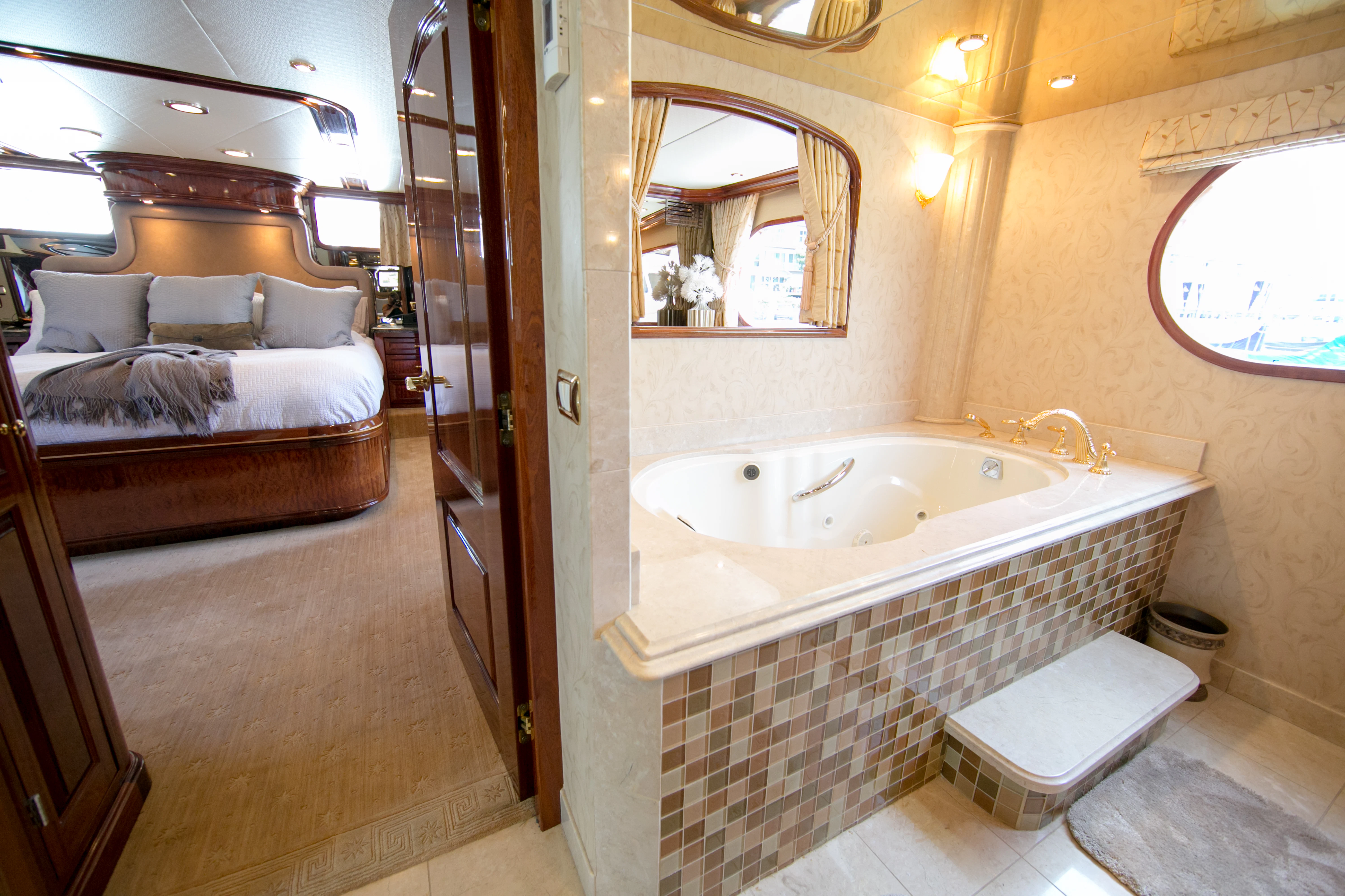 a bathroom with a tub and a bed aboard AURORA Yacht for Sale
