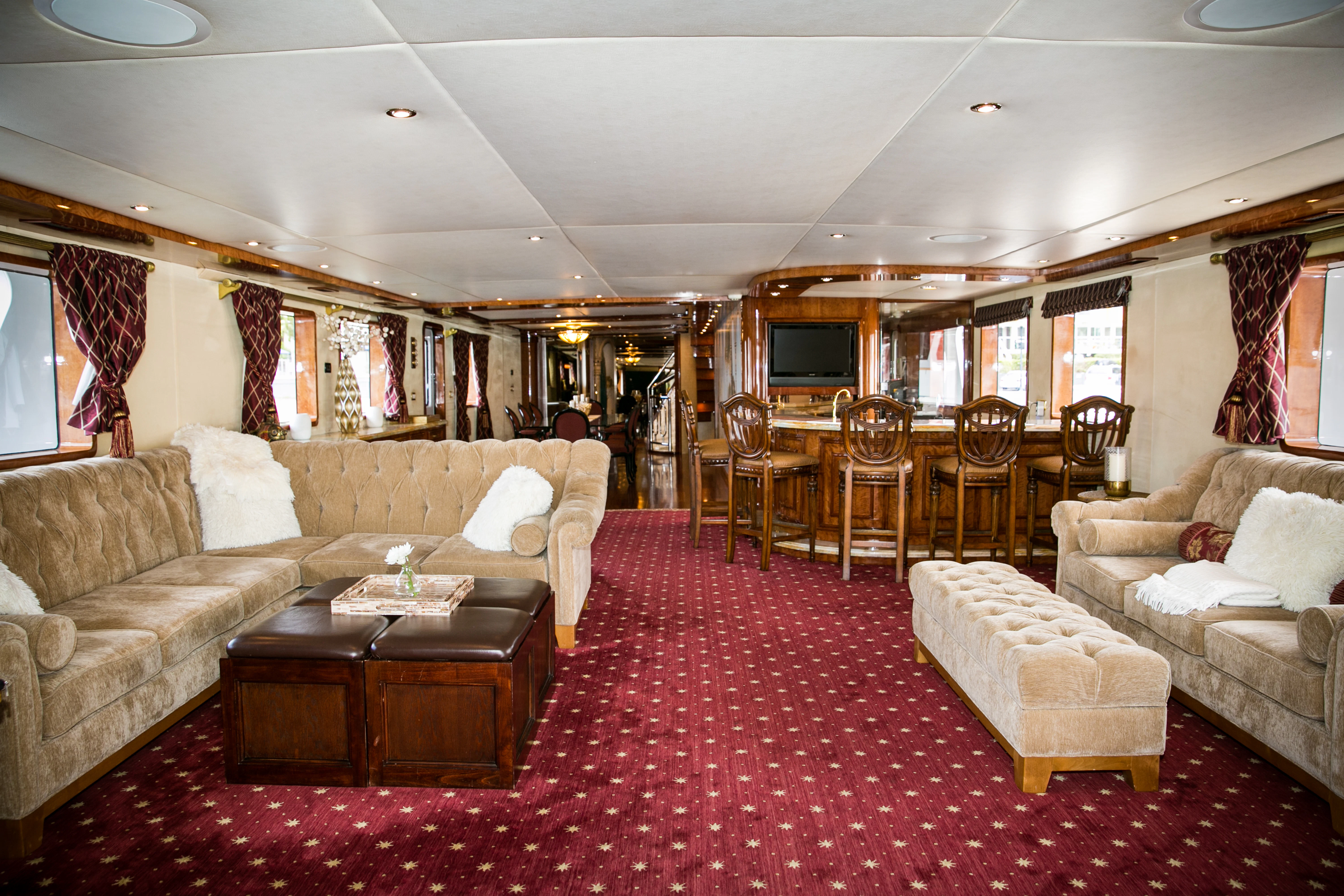 a living room with a couch and a table aboard AURORA Yacht for Sale