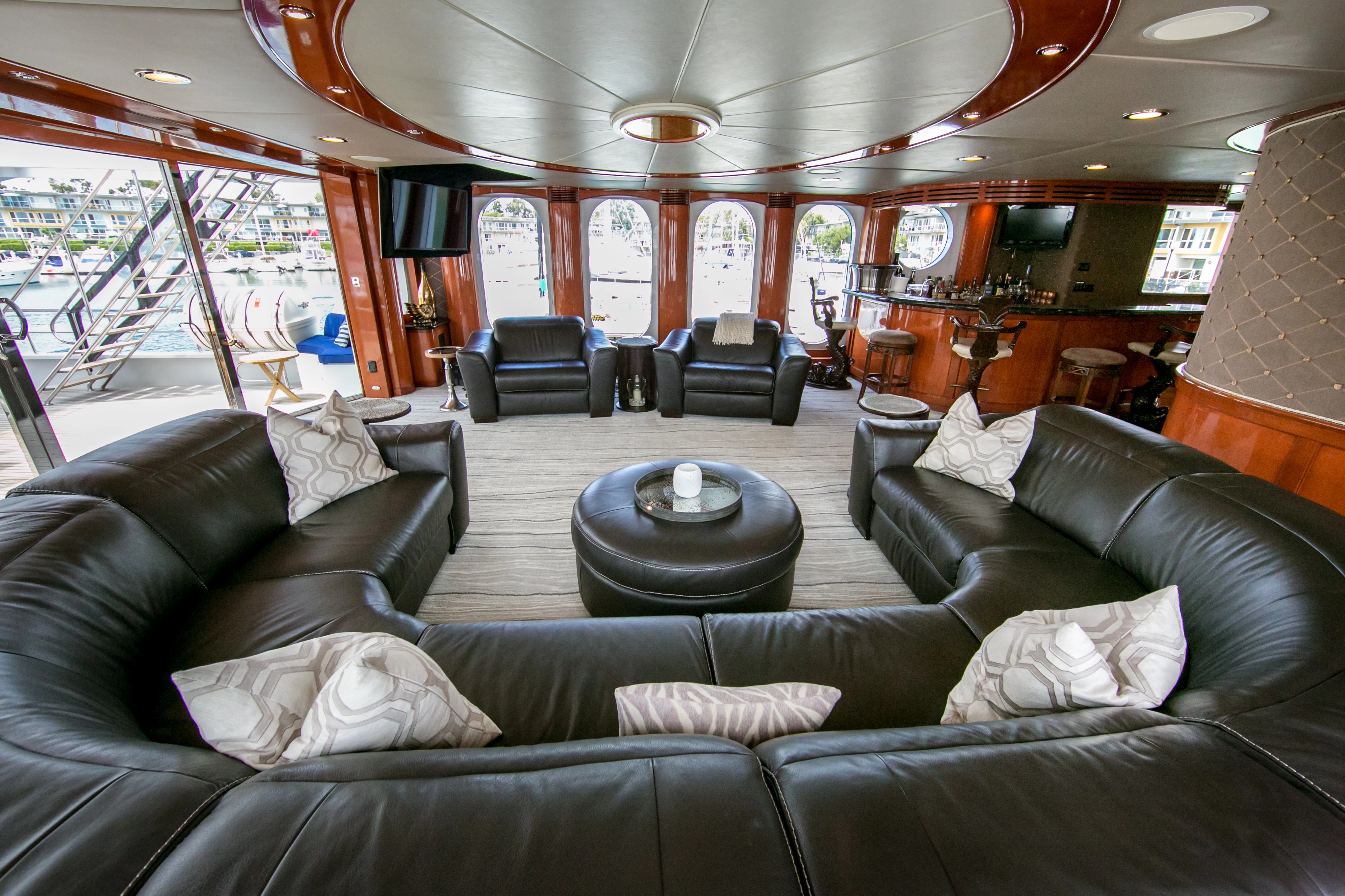 a living room with leather couches aboard AURORA Yacht for Sale