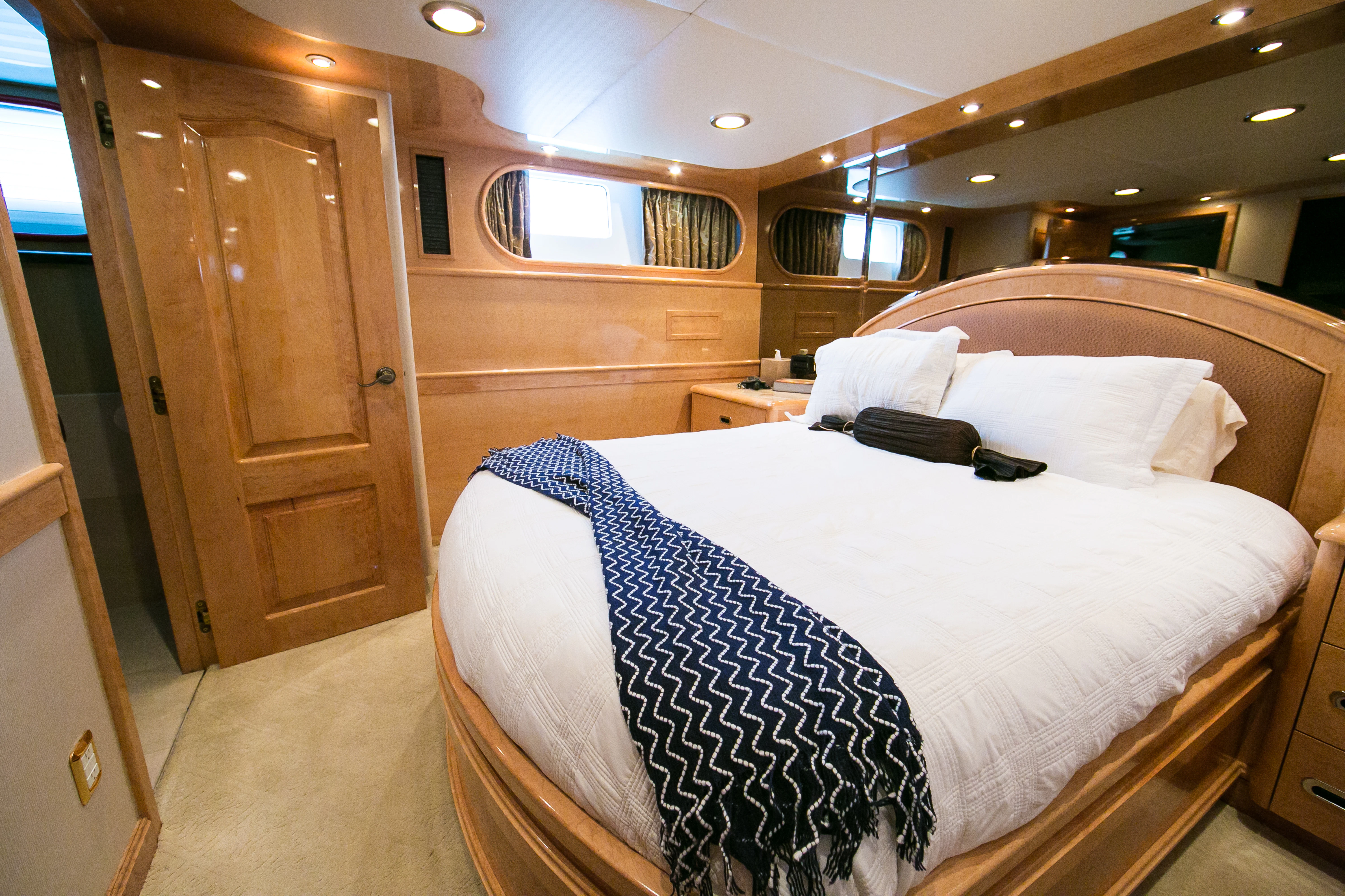 a room with a bed and a closet aboard AURORA Yacht for Sale
