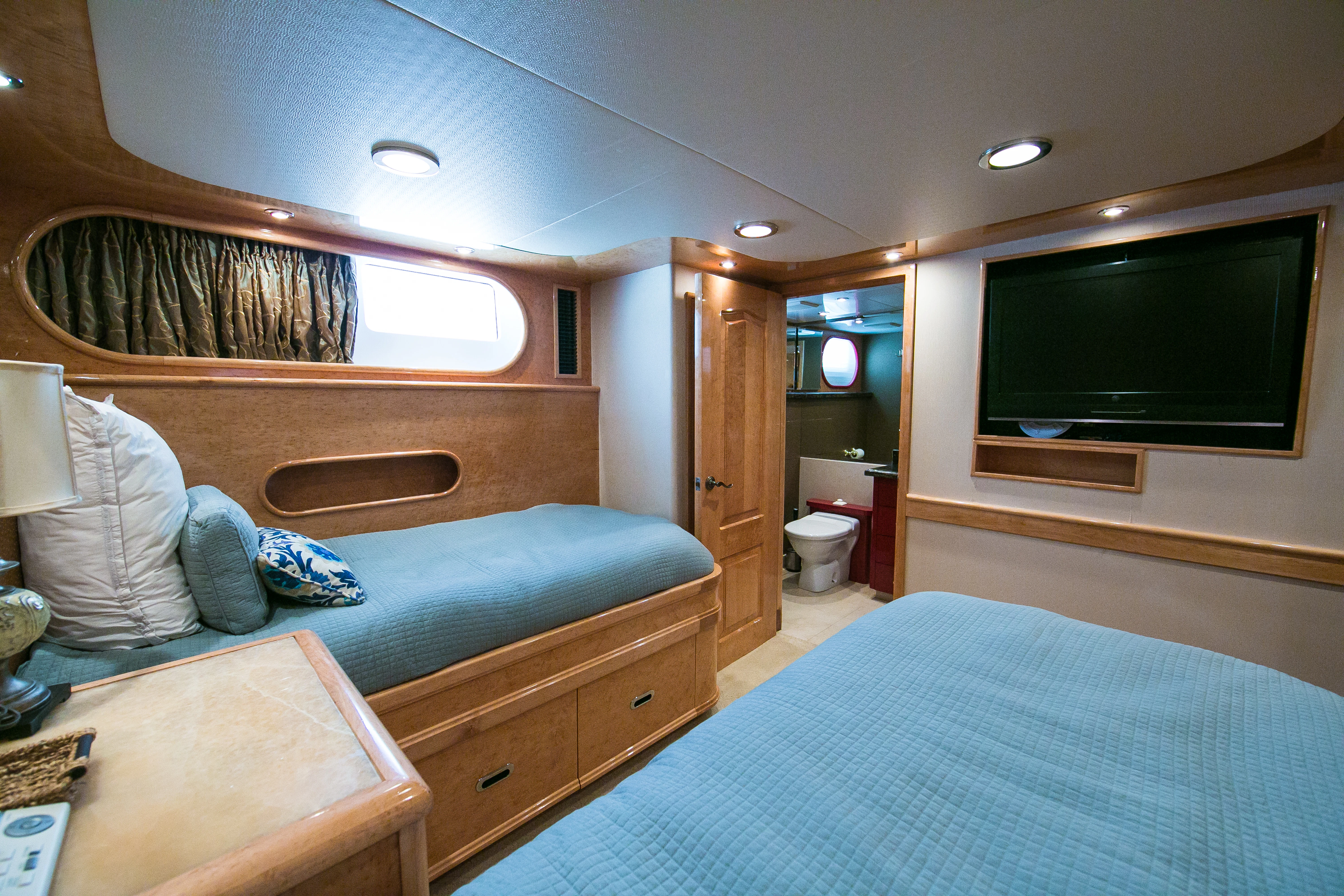 a bedroom with a bed and a television aboard AURORA Yacht for Sale