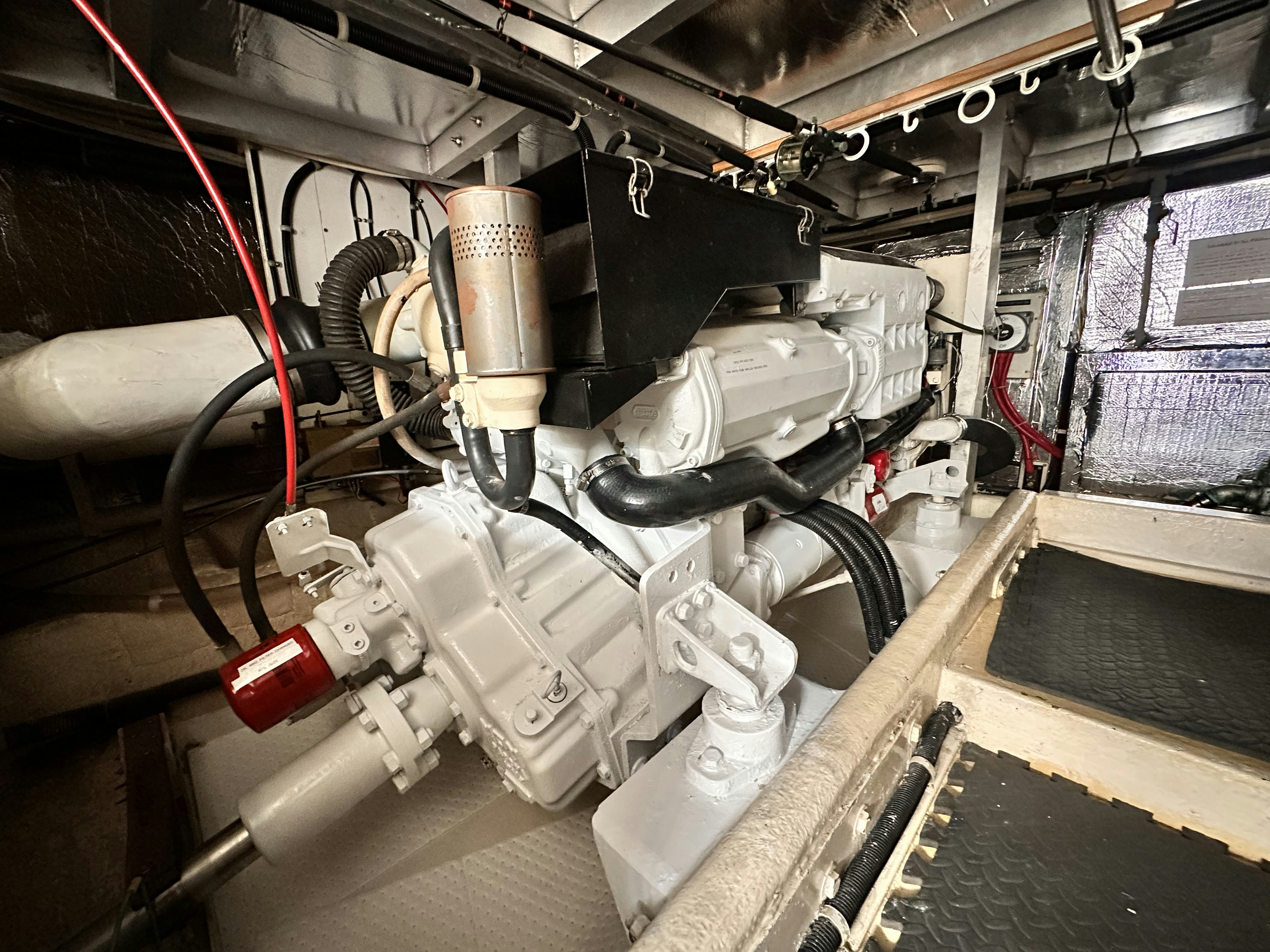 a car engine with a red and white hood aboard BARKRUISER Yacht for Sale
