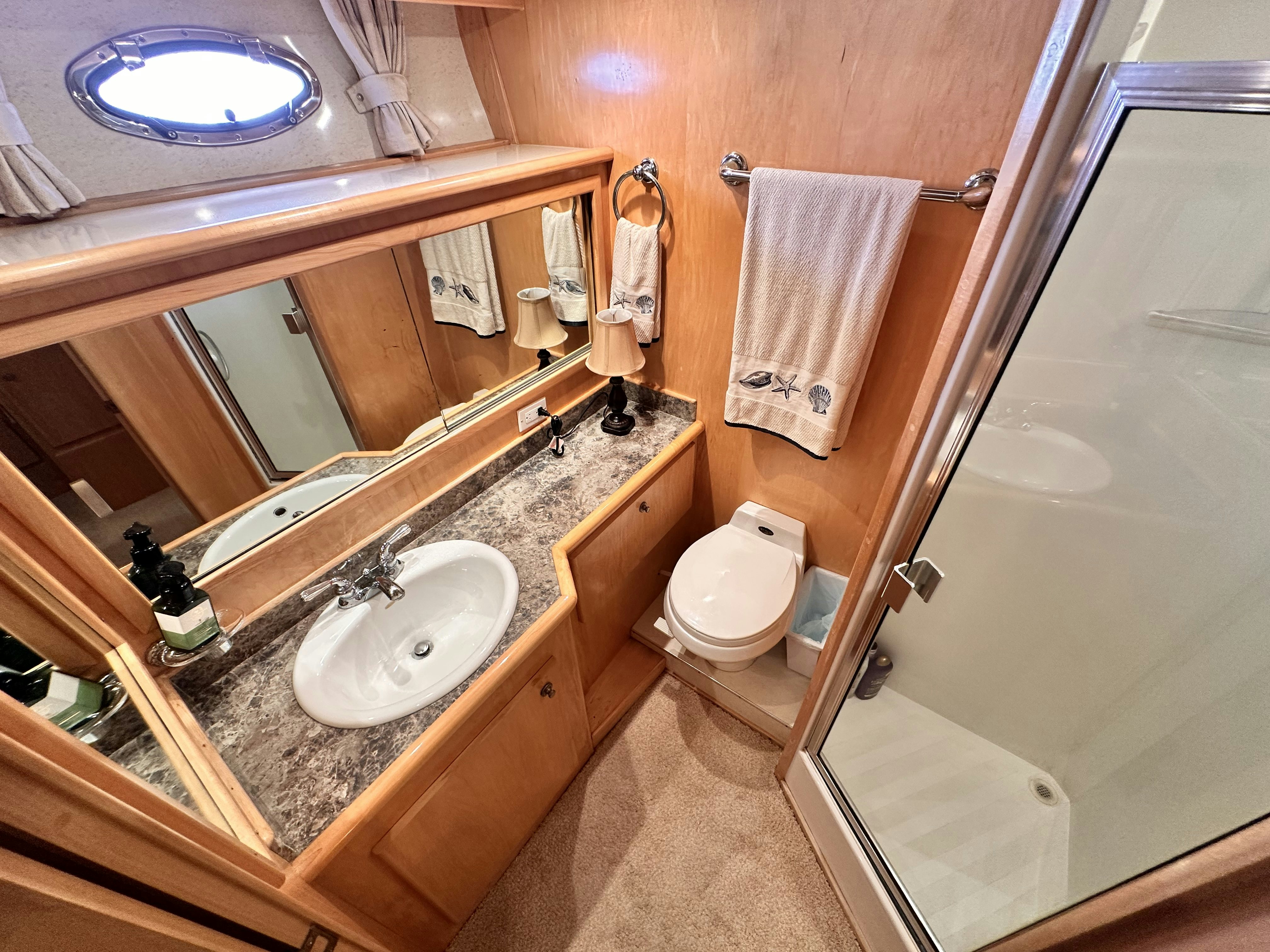 a bathroom with a countertop sink and a toilet aboard BARKRUISER Yacht for Sale