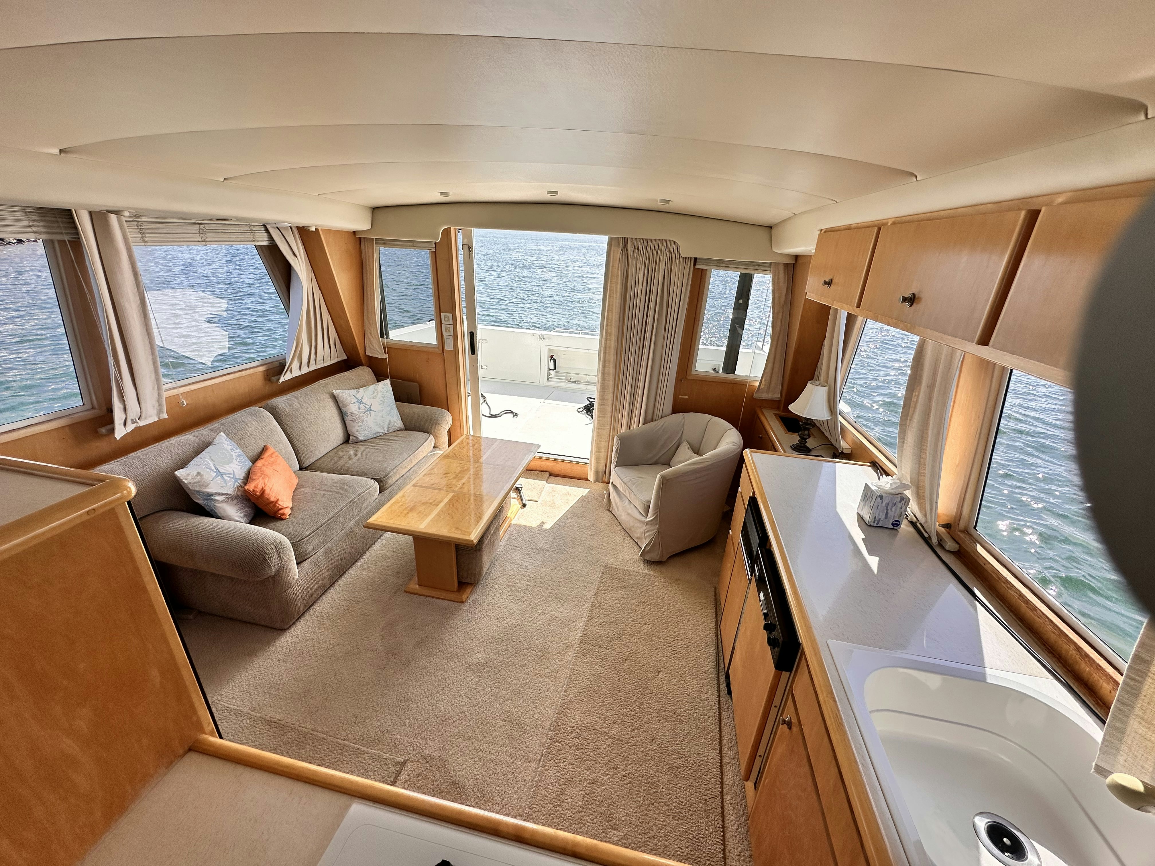 a living room with a large window aboard BARKRUISER Yacht for Sale