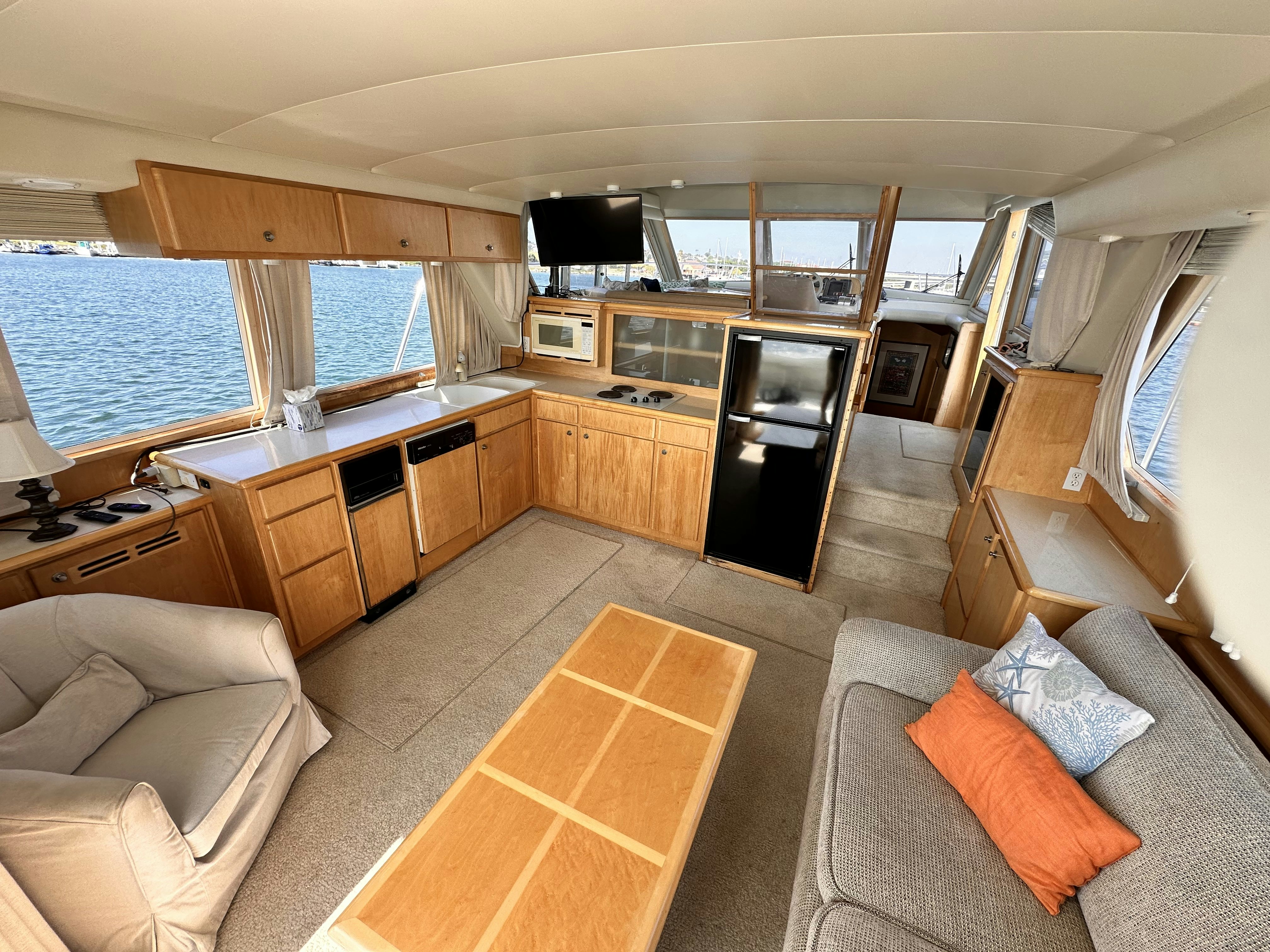 a living room with a couch and a fireplace aboard BARKRUISER Yacht for Sale