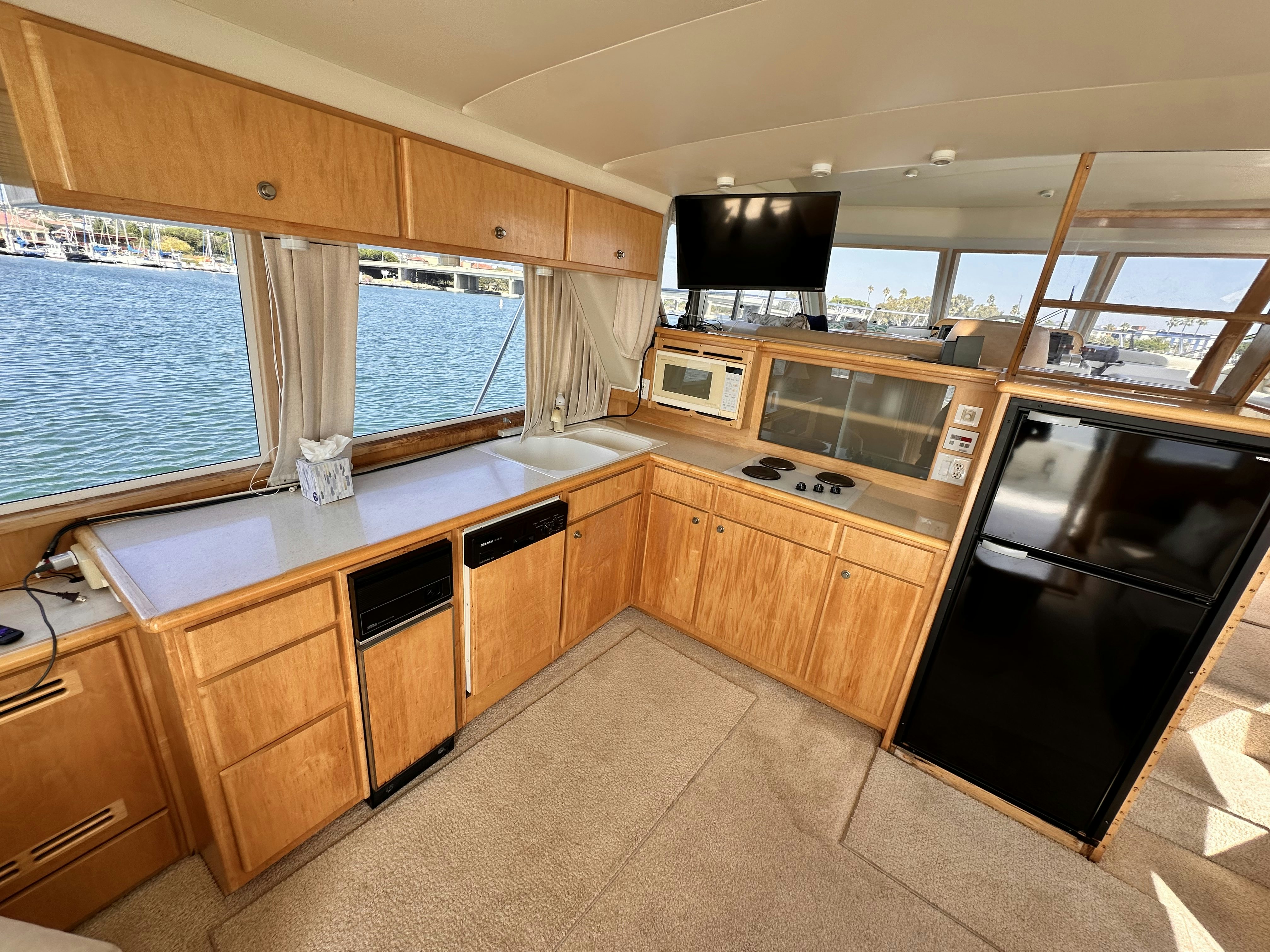 a kitchen with wooden cabinets aboard BARKRUISER Yacht for Sale