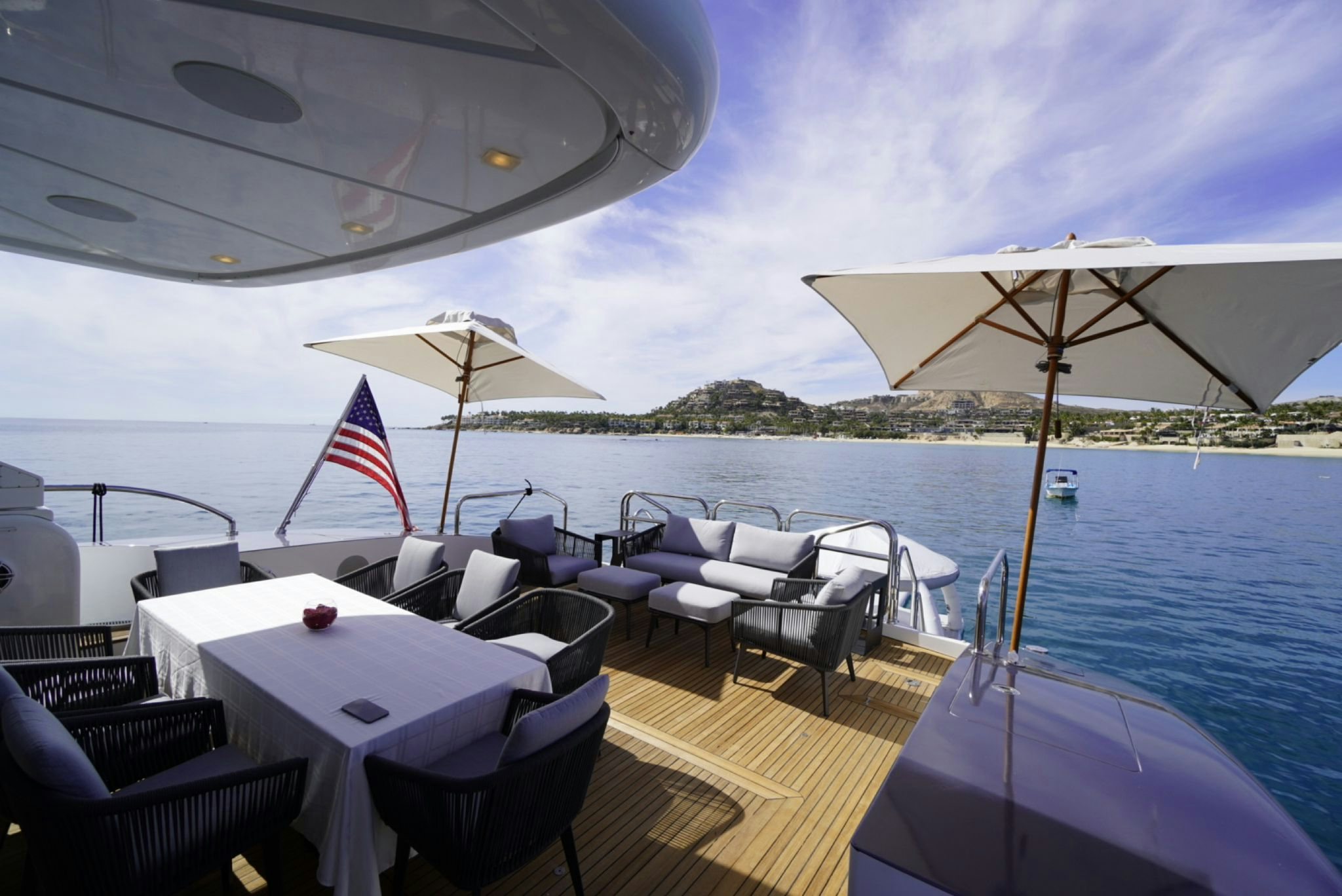 a boat with chairs and umbrellas on a deck aboard GO Yacht for Sale