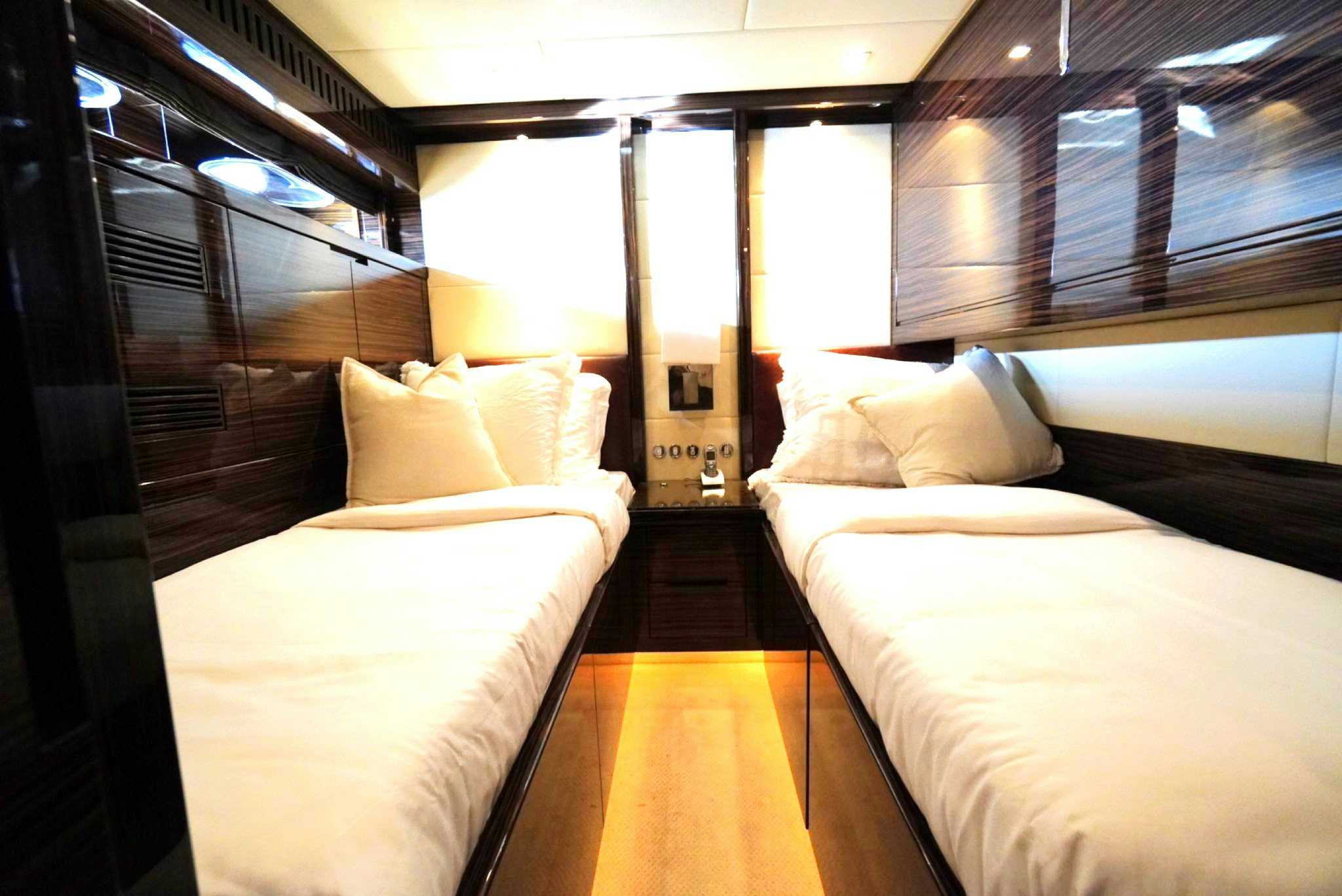 a room with beds and a wood staircase aboard GO Yacht for Sale