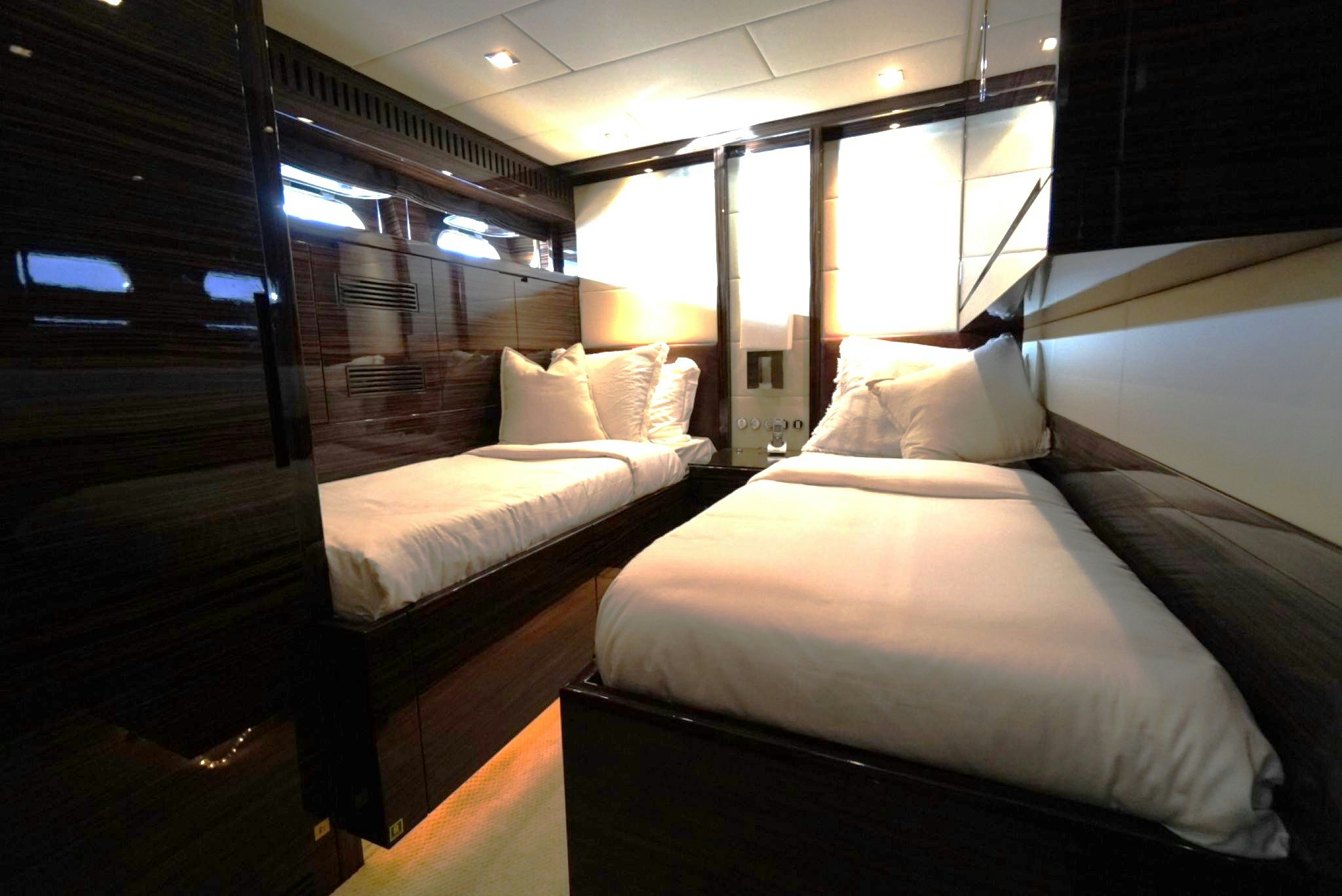 a room with beds and a window aboard GO Yacht for Sale