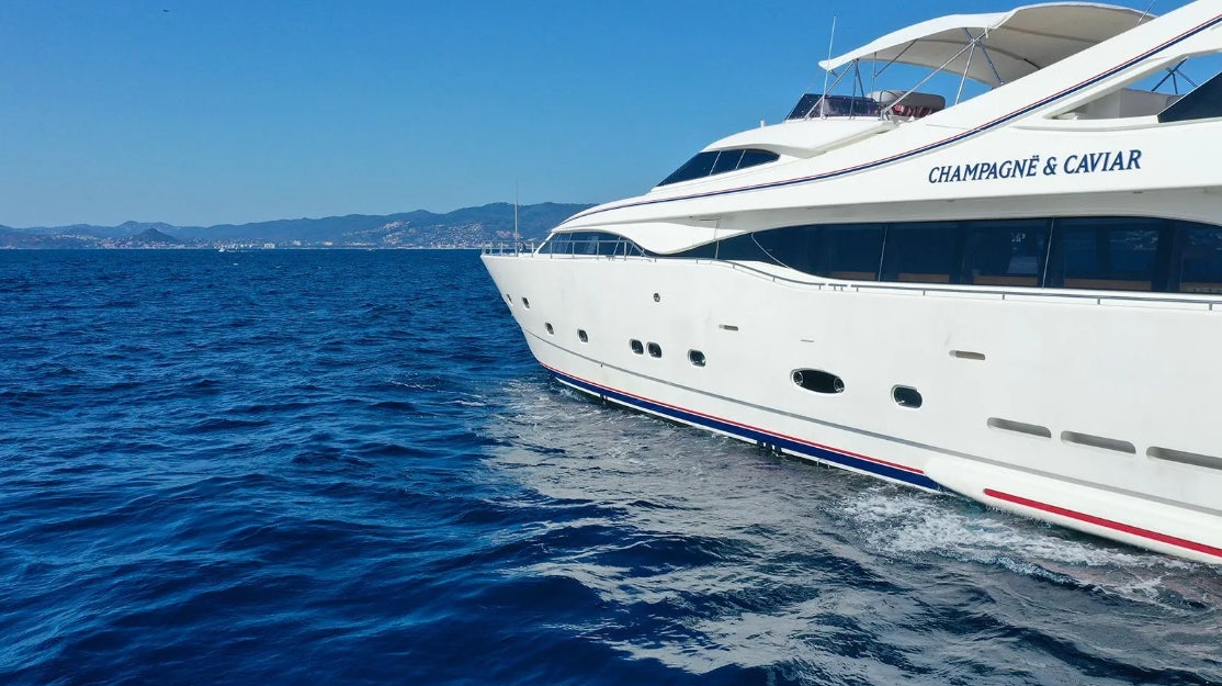 a couple of white yachts in the water aboard CHAMPAGNE & CAVIAR Yacht for Charter