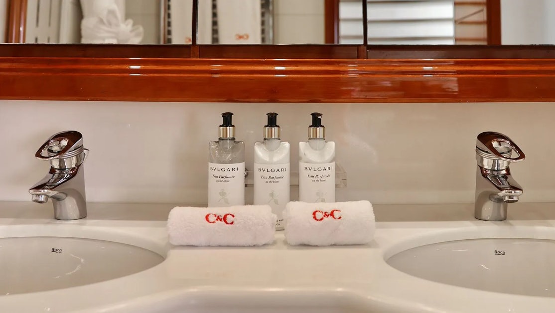 a sink with a lot of toiletries on it aboard CHAMPAGNE & CAVIAR Yacht for Charter