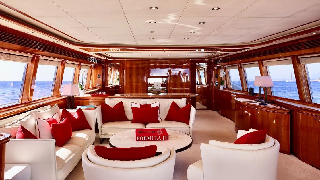 a room with couches and a table aboard CHAMPAGNE & CAVIAR Yacht for Charter