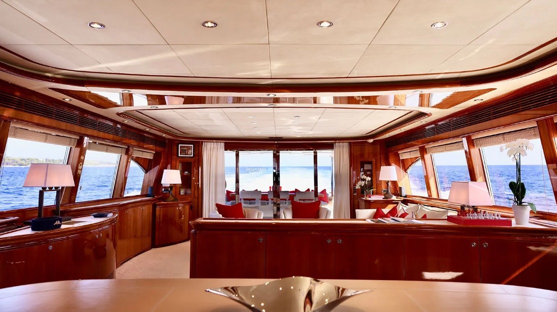 a room with a table and chairs aboard CHAMPAGNE & CAVIAR Yacht for Charter