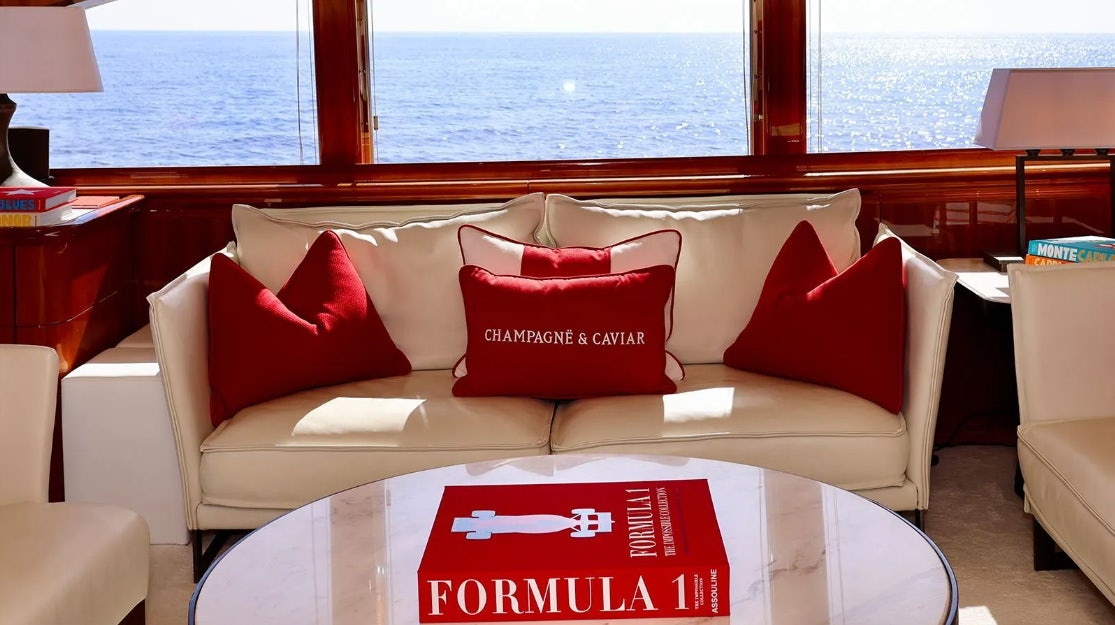 a couch with pillows on it aboard CHAMPAGNE & CAVIAR Yacht for Charter