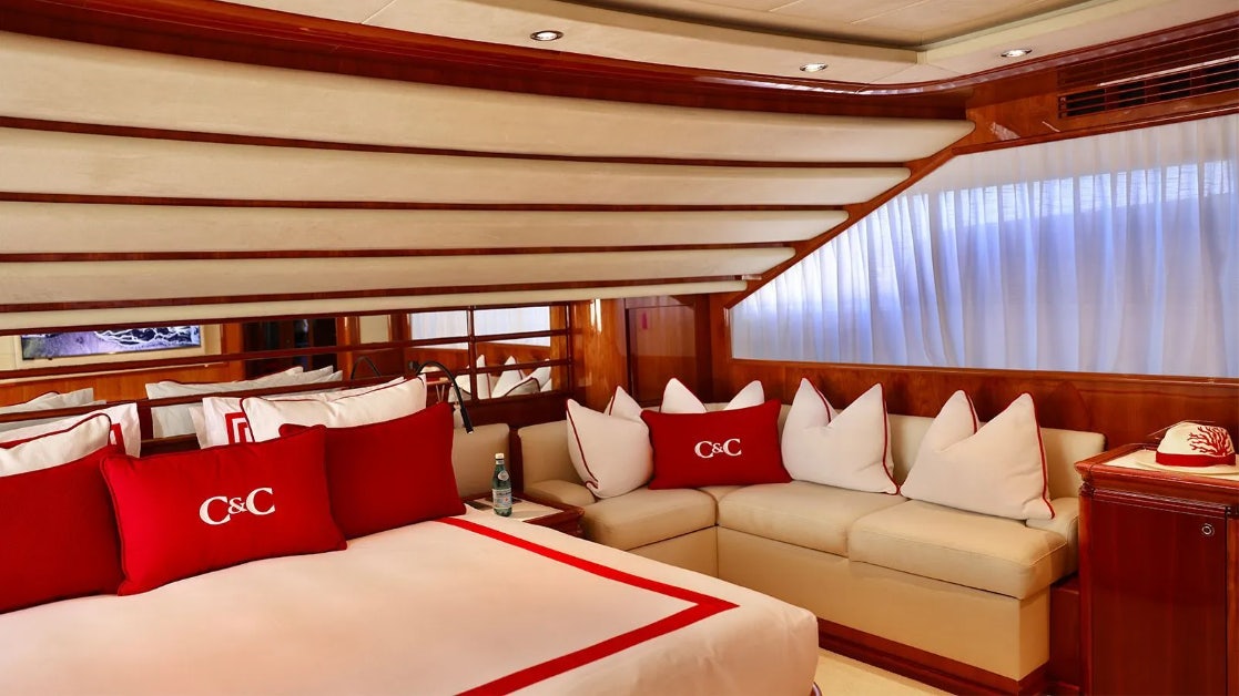 a room with a bed and a couch aboard CHAMPAGNE & CAVIAR Yacht for Charter