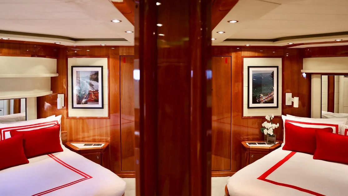 a room with red pillows and a mirror aboard CHAMPAGNE & CAVIAR Yacht for Charter