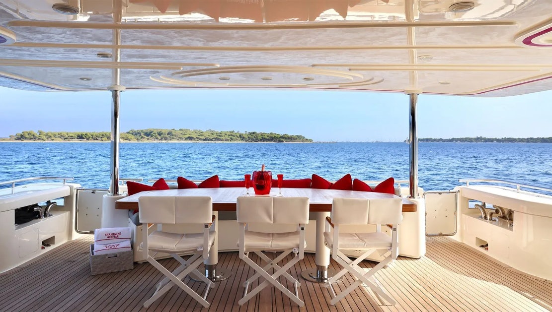 a boat with chairs on the deck aboard CHAMPAGNE & CAVIAR Yacht for Charter