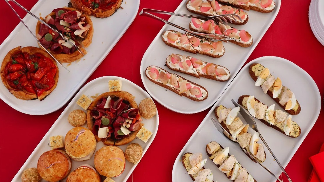 a table with plates of food aboard CHAMPAGNE & CAVIAR Yacht for Charter