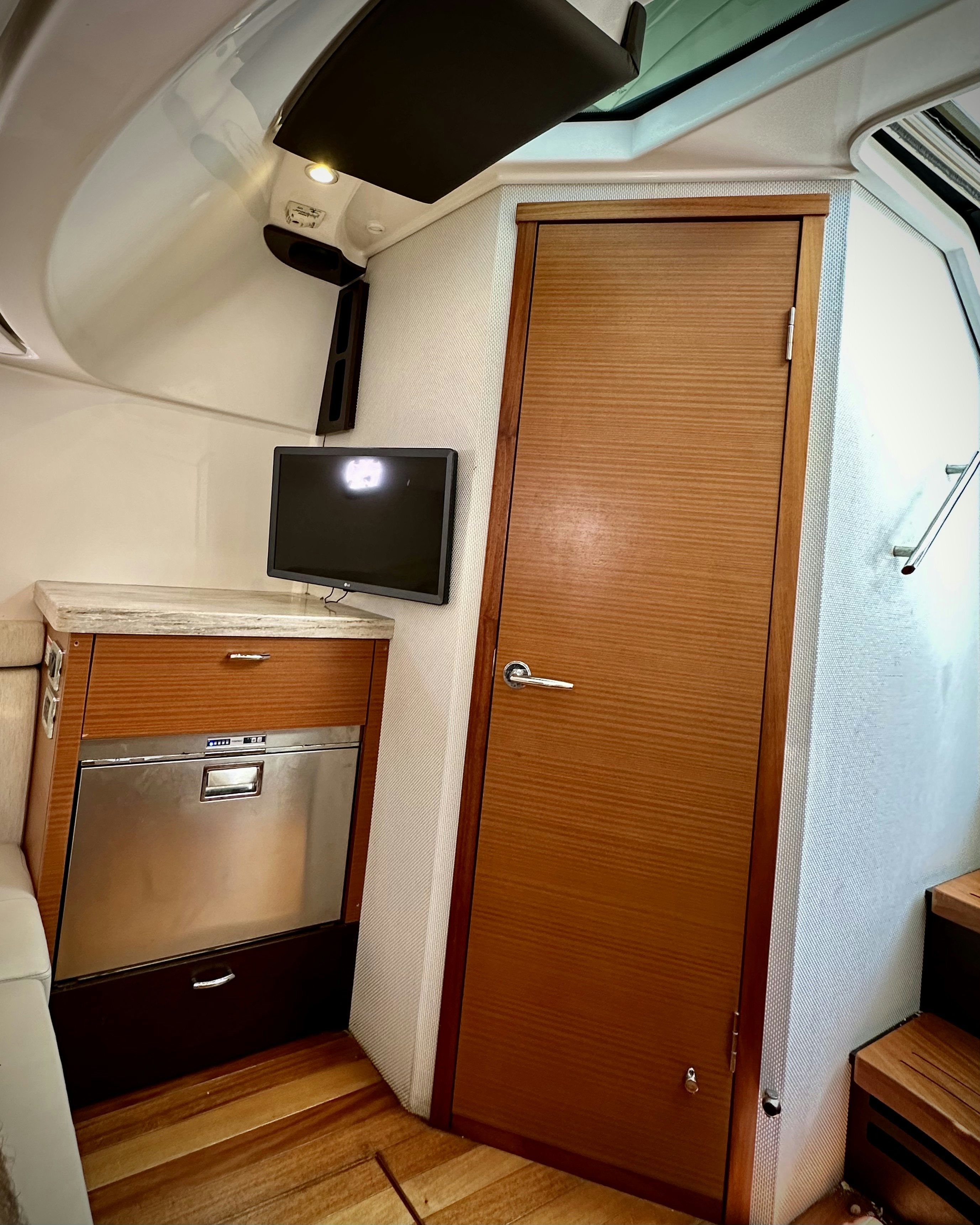 a room with a tv and a cabinet aboard PURSUIT S 408 Yacht for Sale