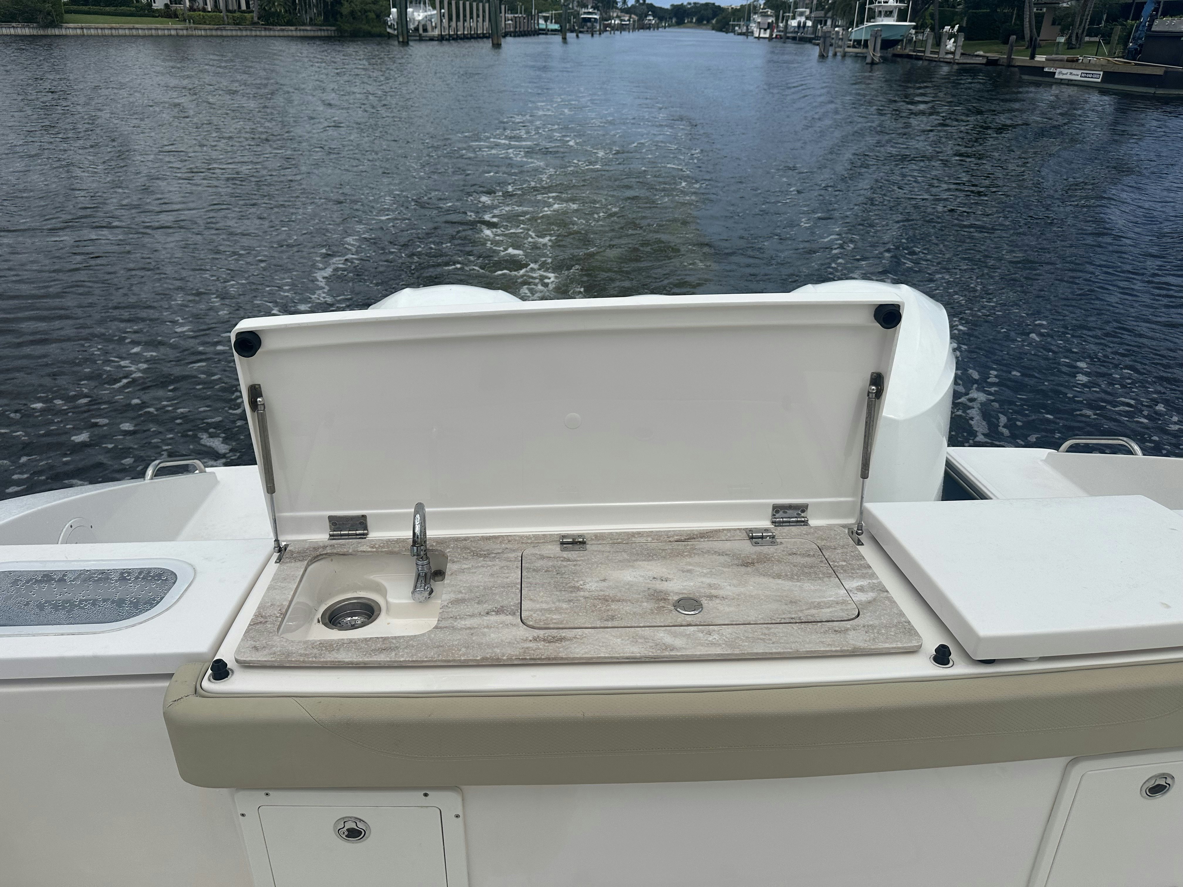 a white boat on a body of water aboard PURSUIT S 408 Yacht for Sale